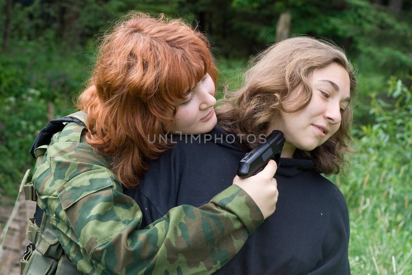 Airsoft thriller: two girls and pistol

