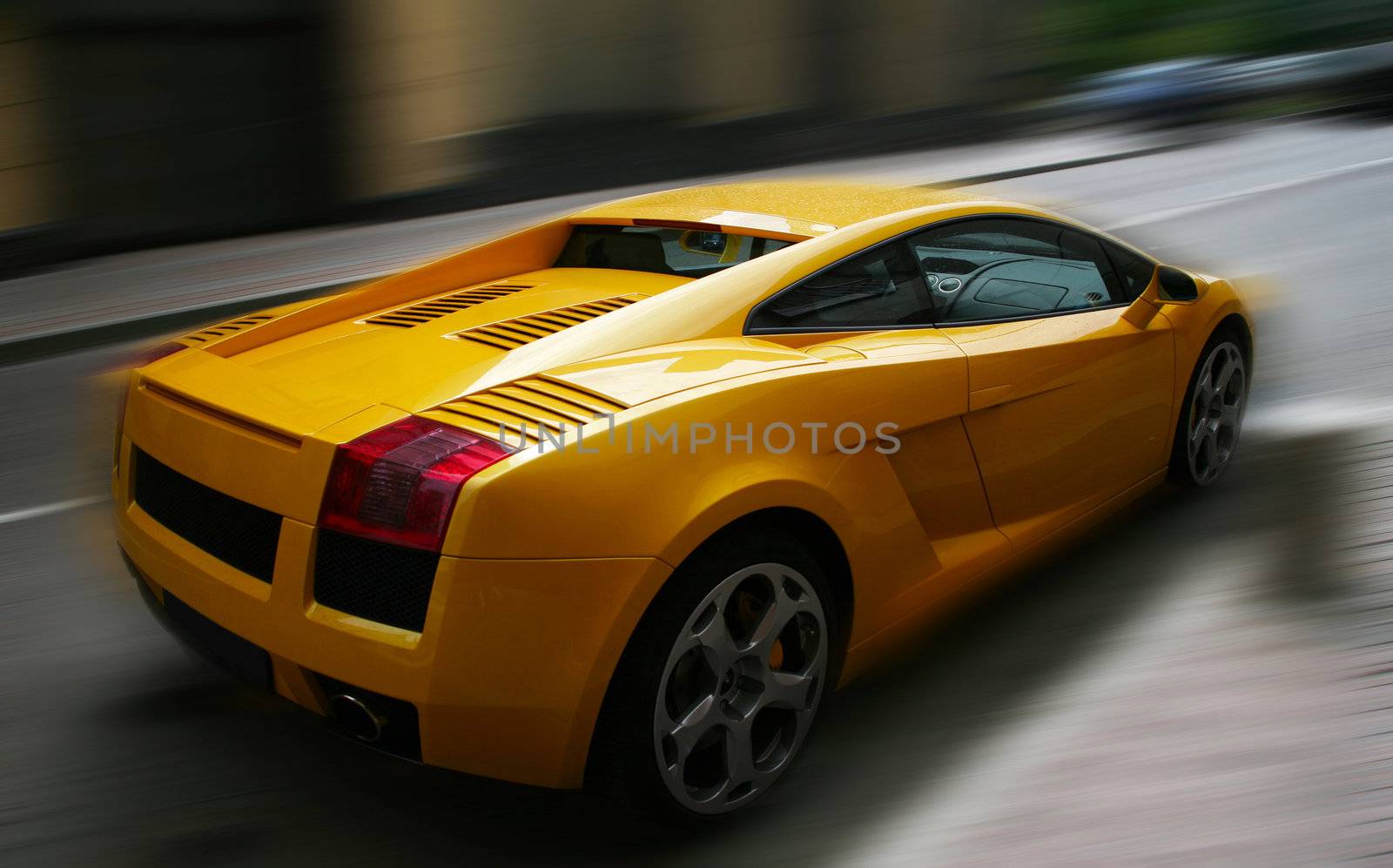 The image of the yellow respectable automobile on a dim background