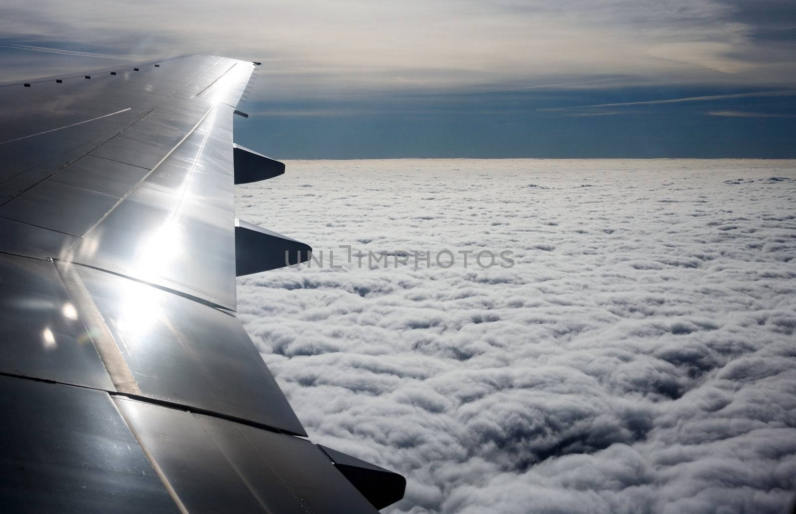 Wing of the plane on a background of clouds