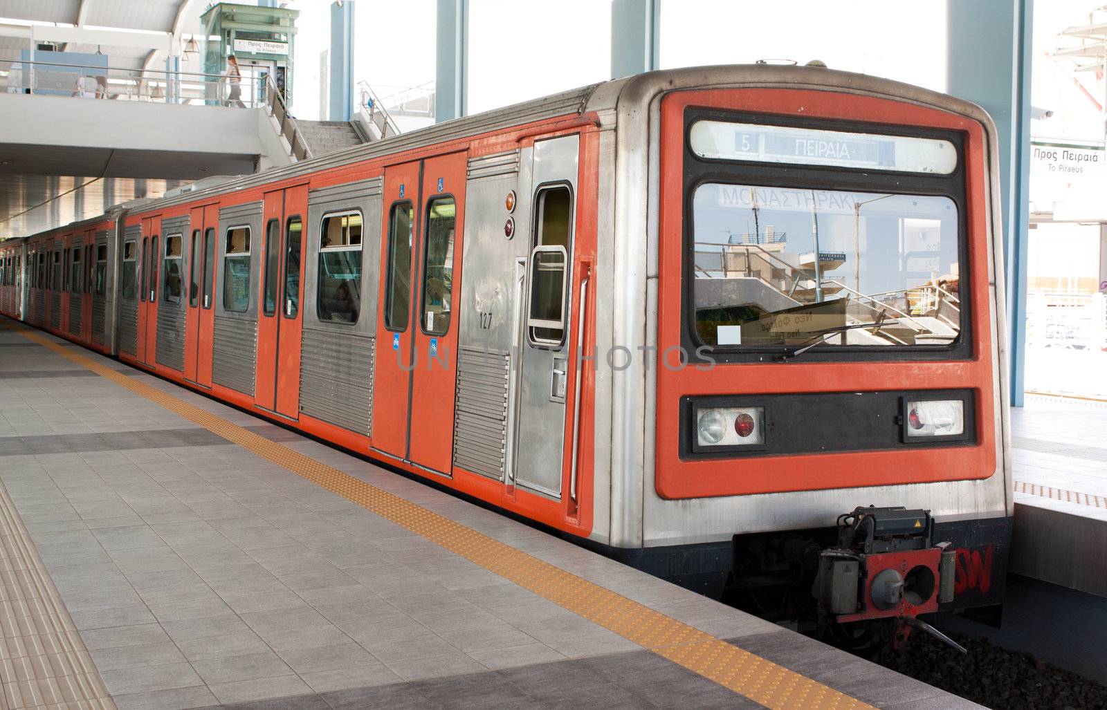 Underground station in Piraeus area, Athens, Greece and train running from Pireaus to Monastiraki.