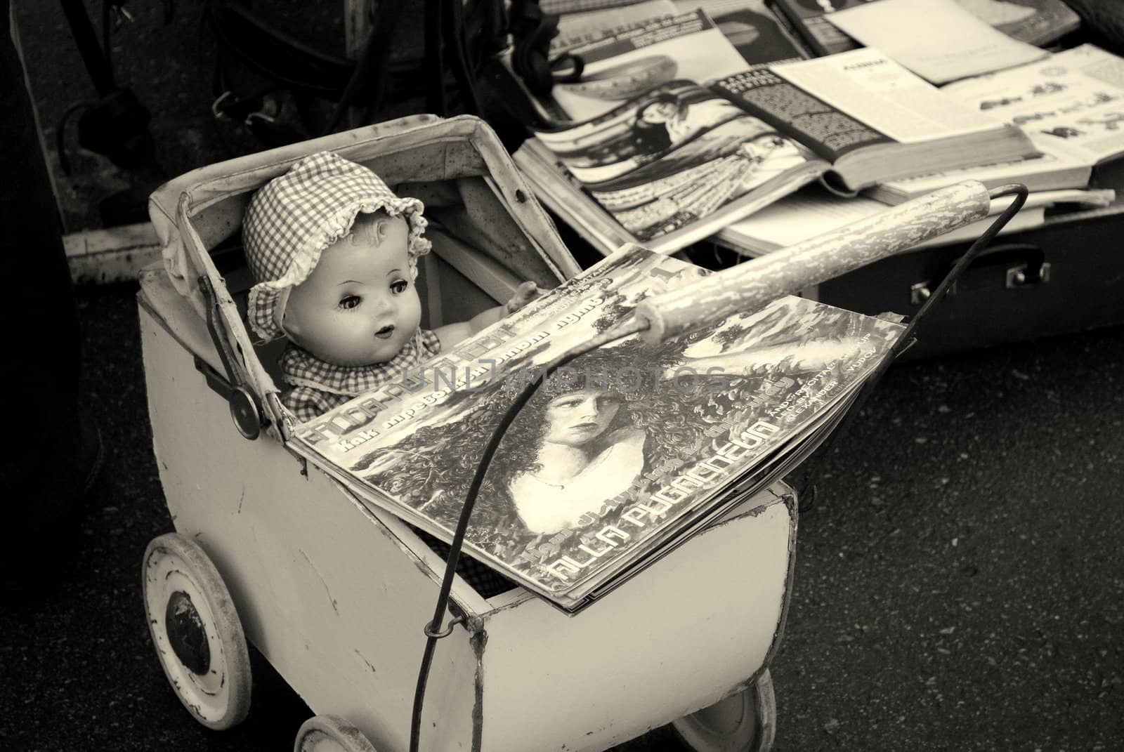 a vintage doll in a buggy with vinyls for sale