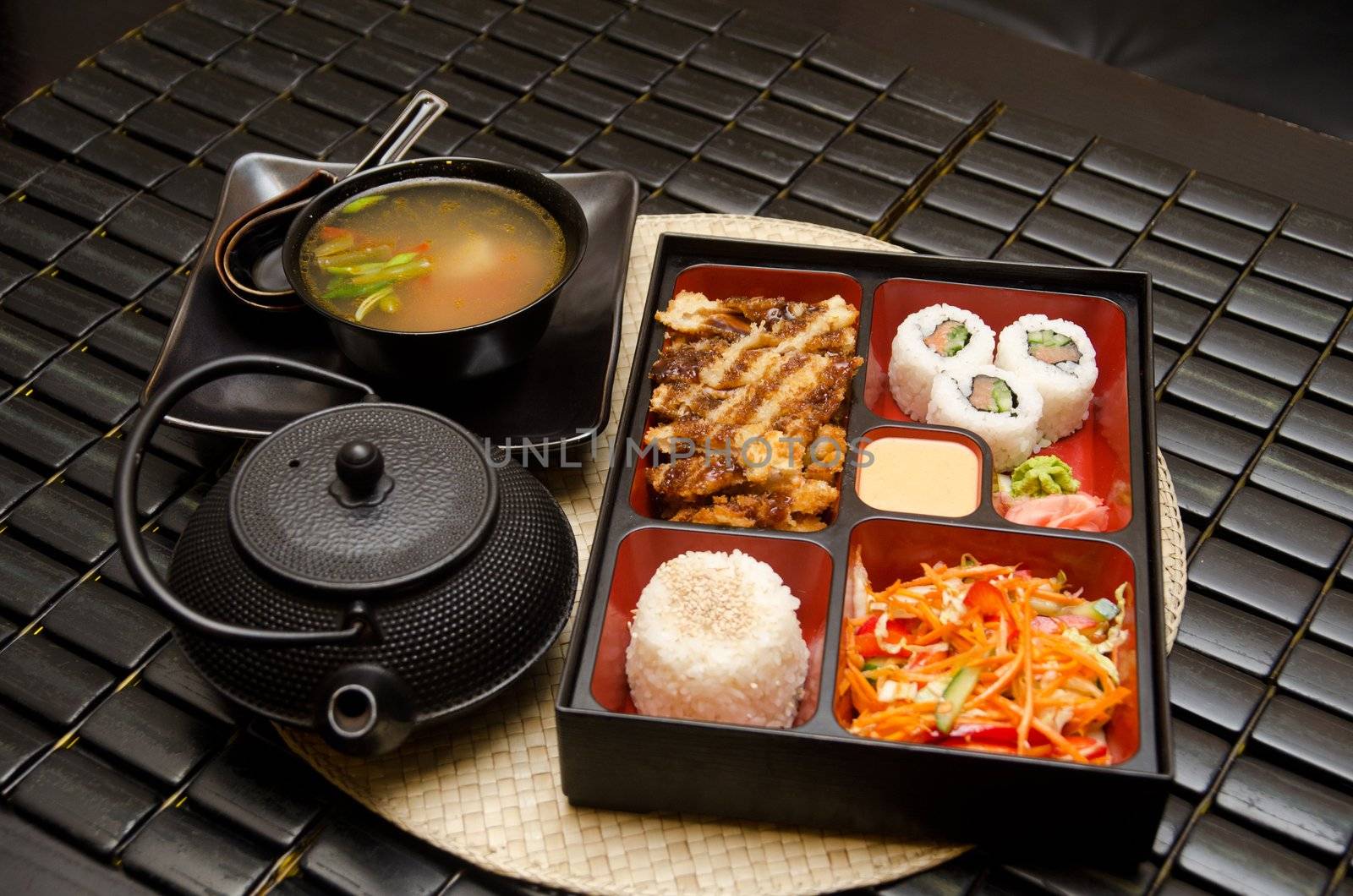 Sushi lunch with soup salad tea and sauce