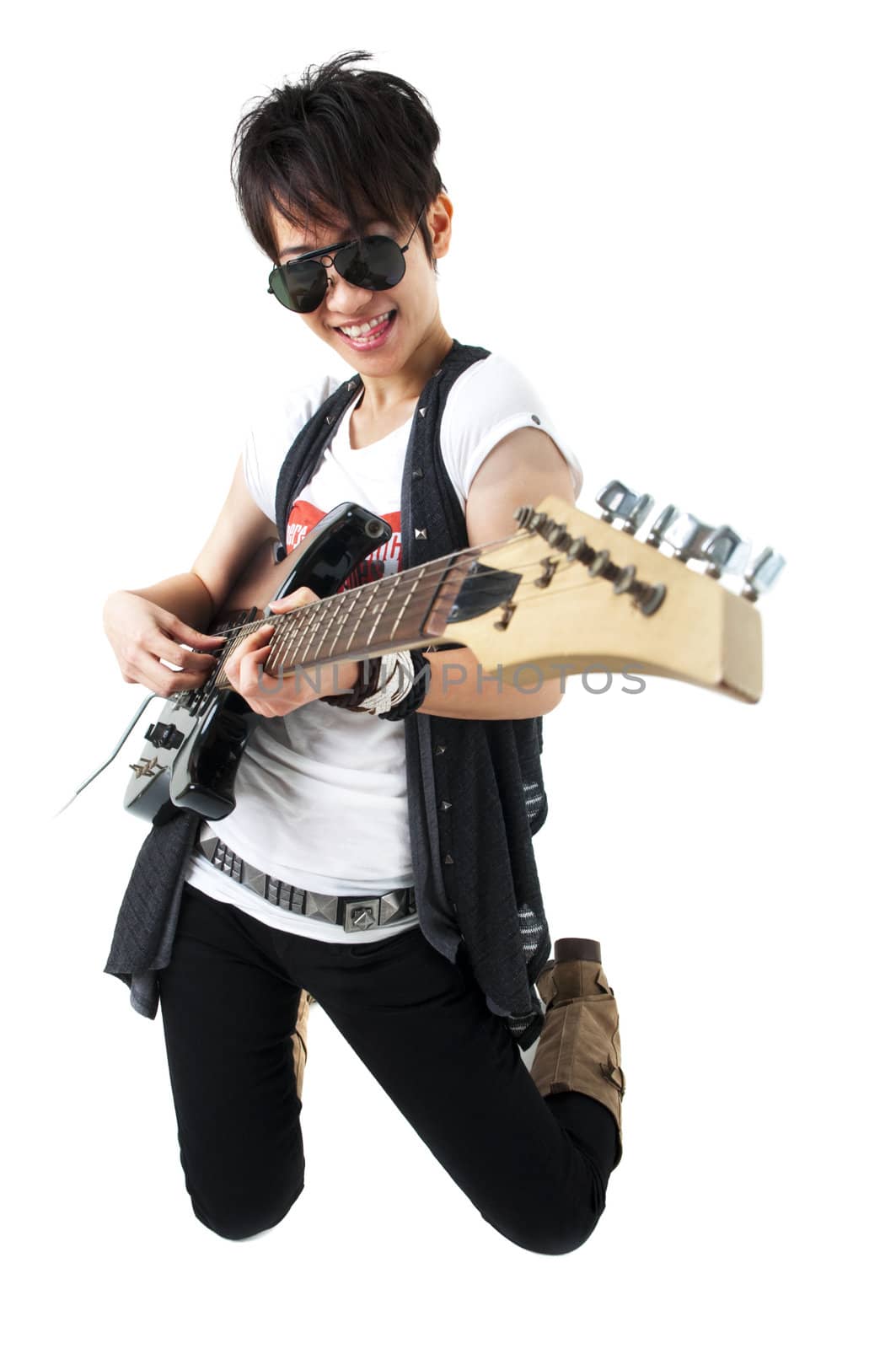 Punk Rockstar holding a guitar kneeling isolated in white