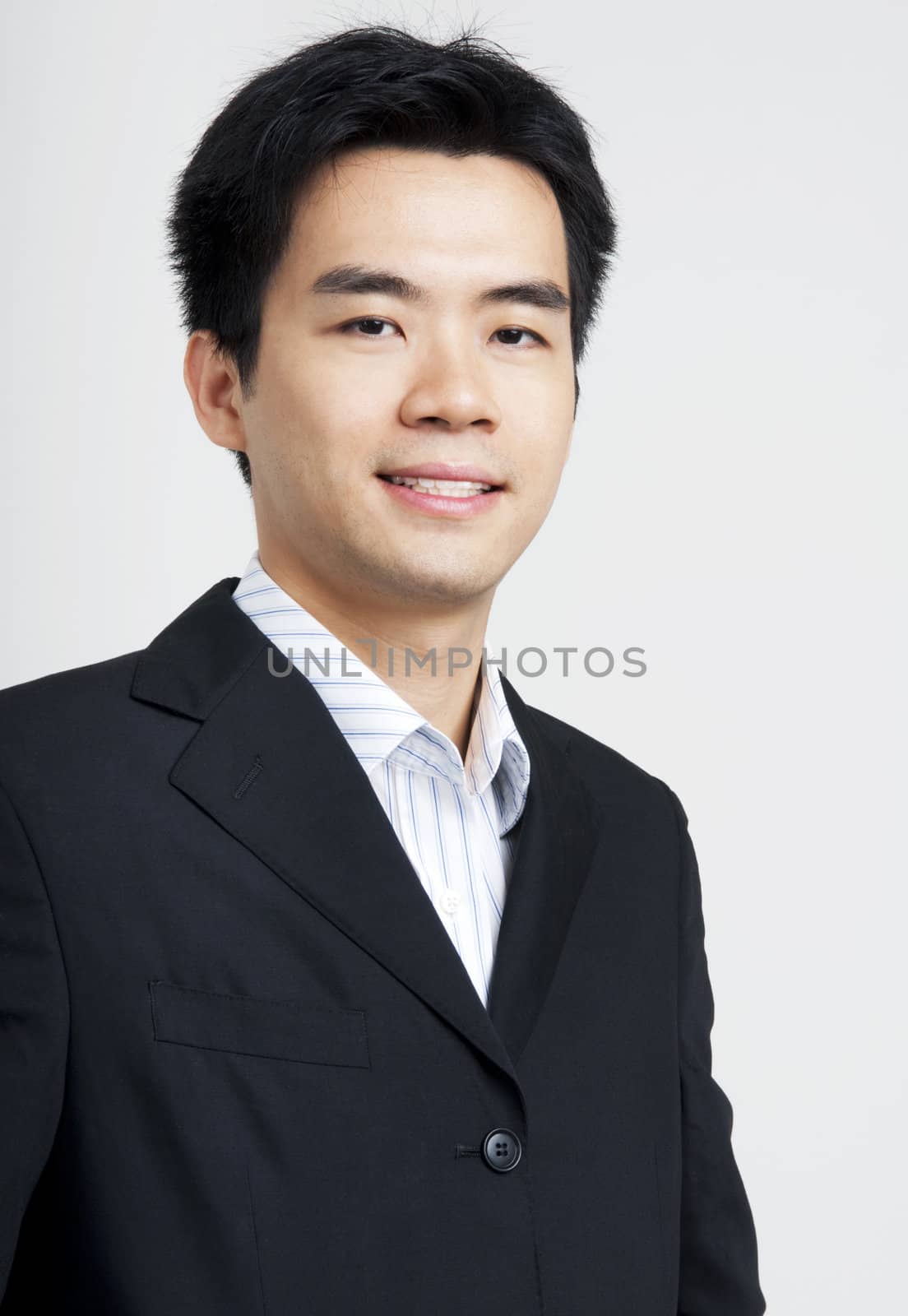 Portrait of young Asian executive in black suit
