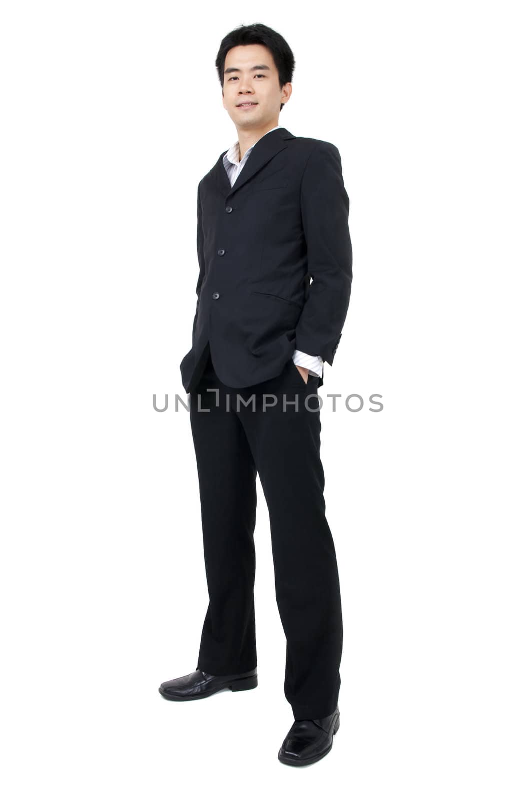 Full body of a smiling young Asian executive standing against isolated white background