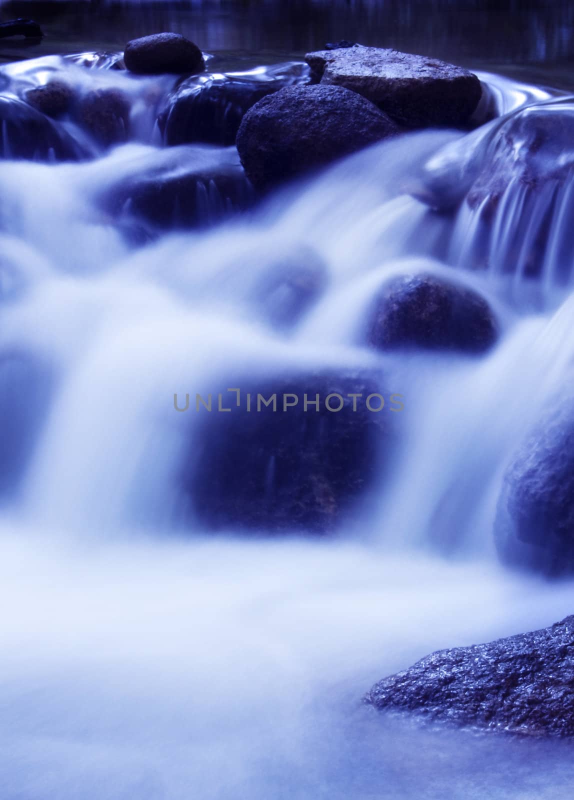 Natural waterfall in tropical rainforest Malaysia in early morning.