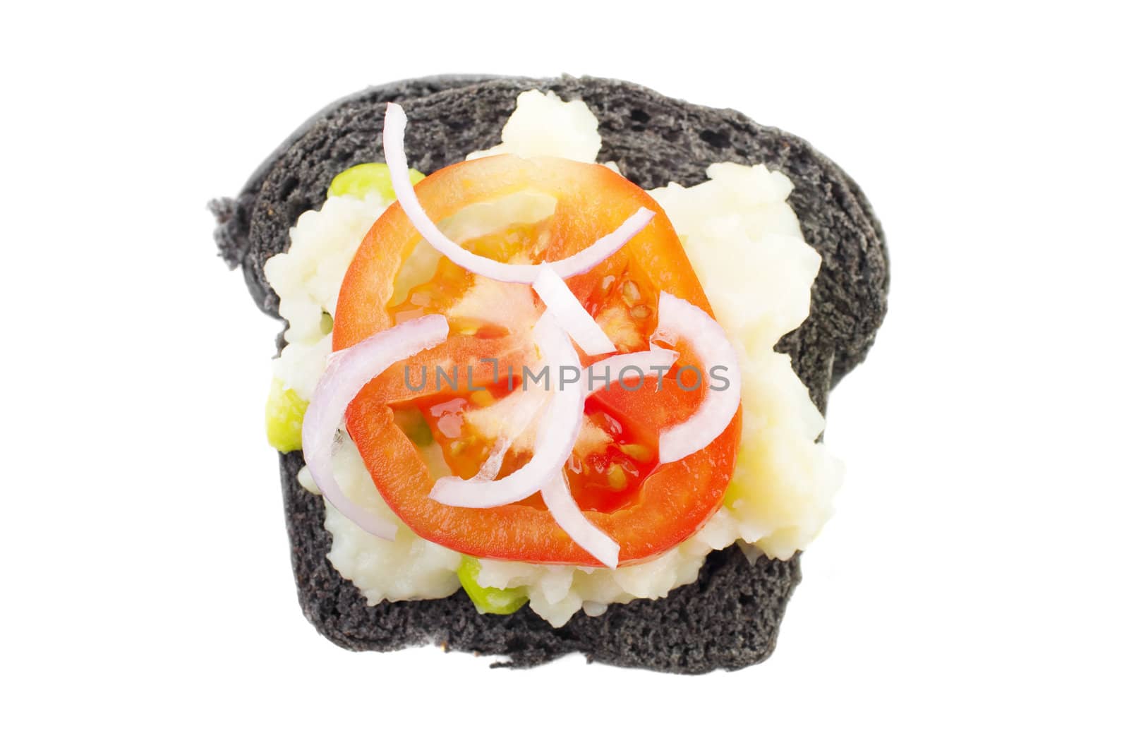 Black charcoal sandwich topped with mashed potato, tomato and onion.