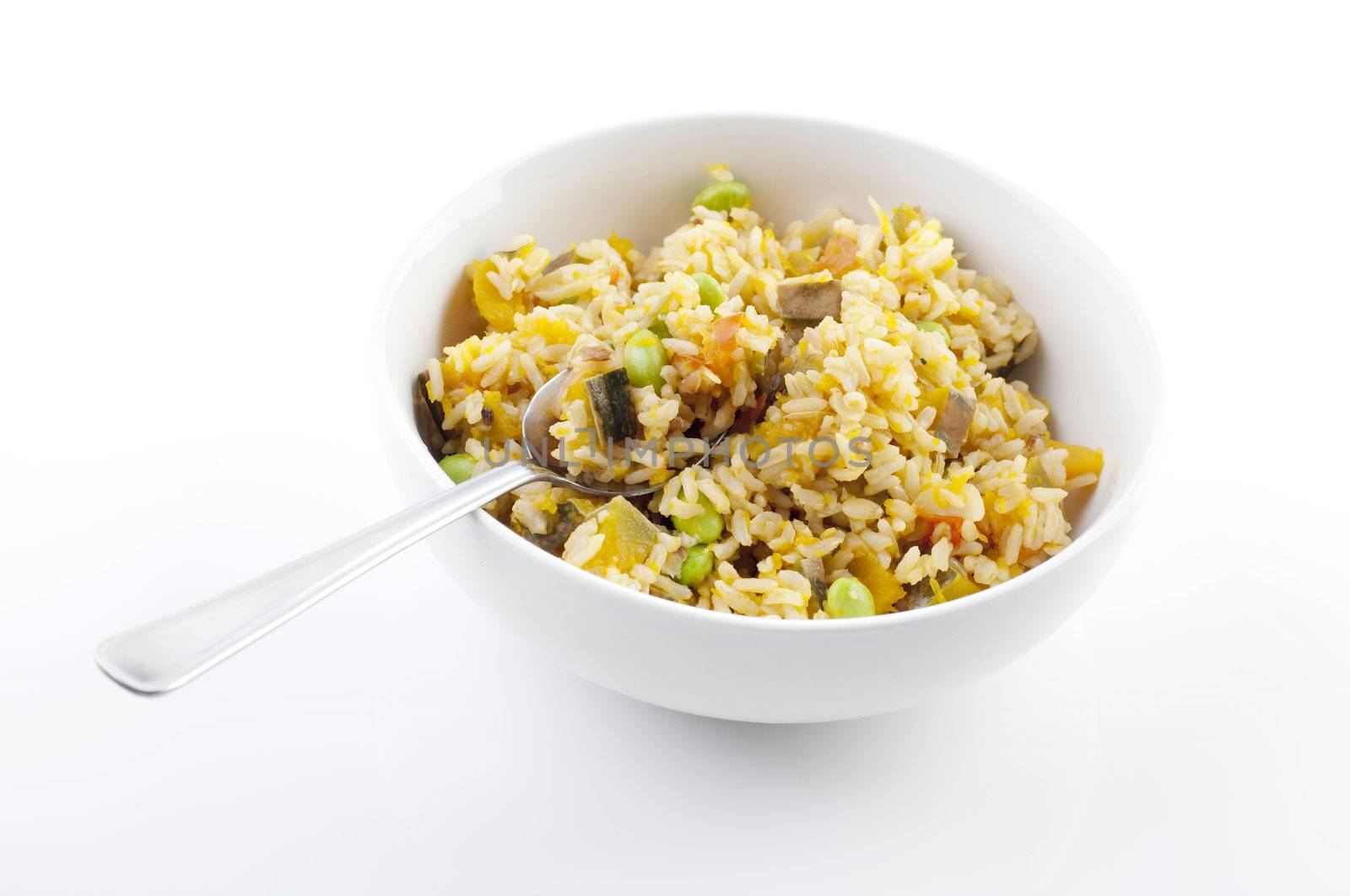 Bowl of pumpkin fried rice on white background
