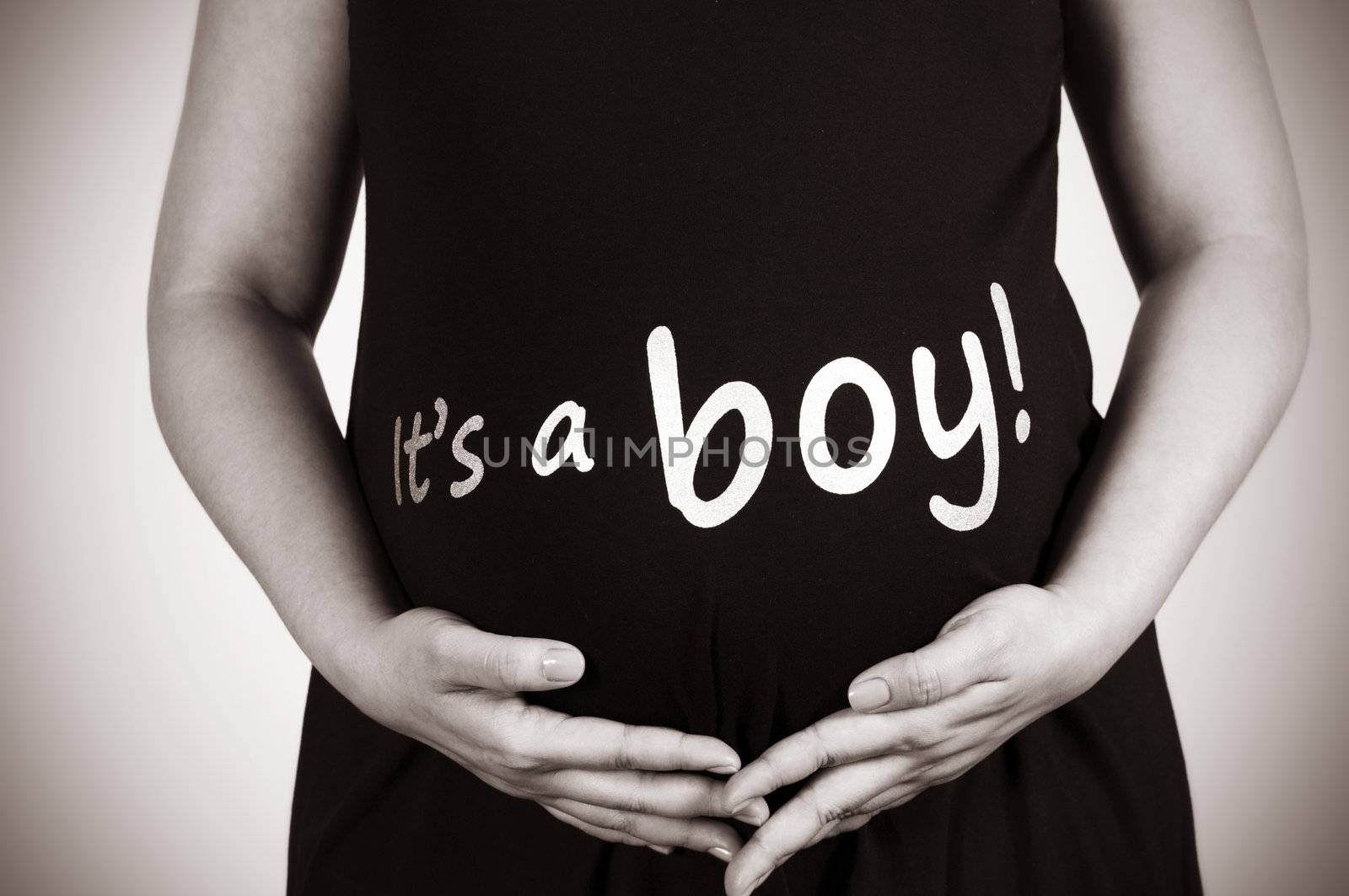 Pregnant women holding her stomach. In sepia tone.