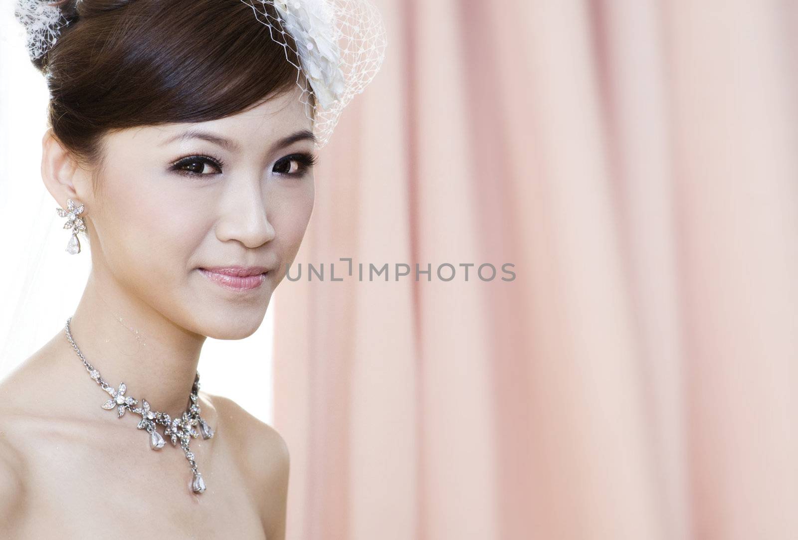 Beautiful Young Asian bride smiling, focus on foreground