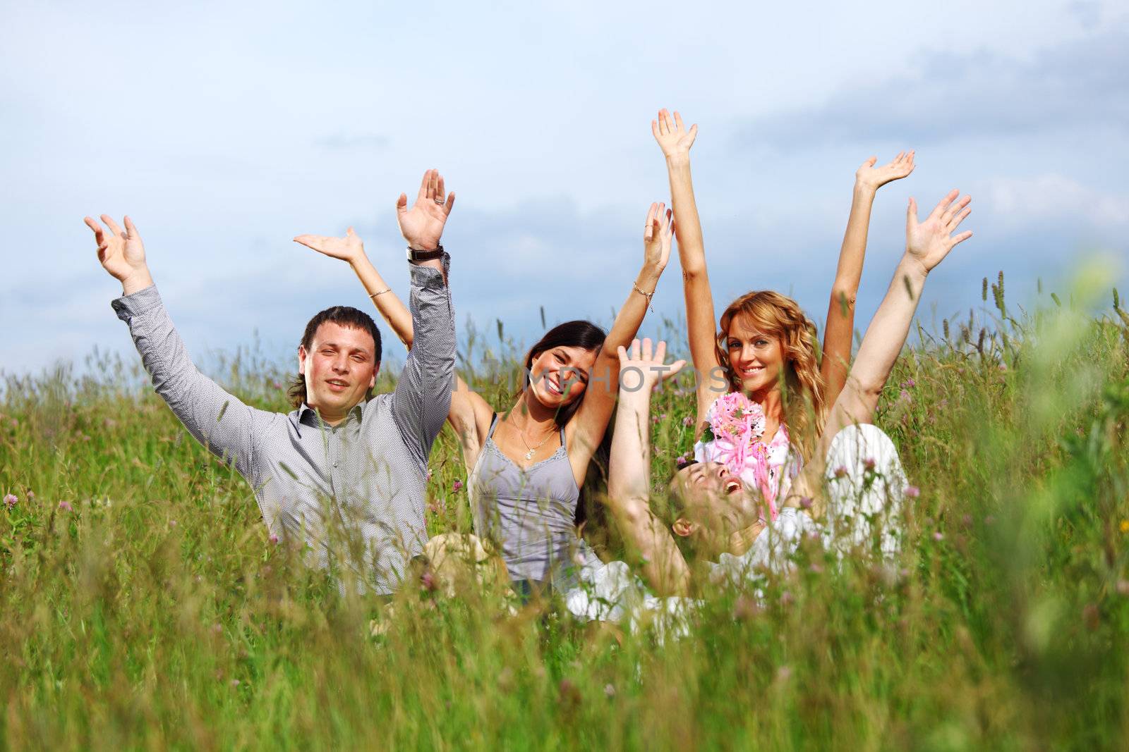 friends and dog in green grass field