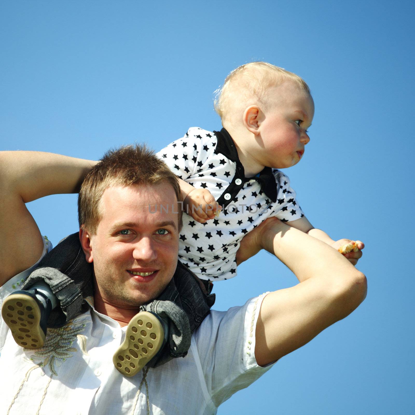 father and son in blue sky