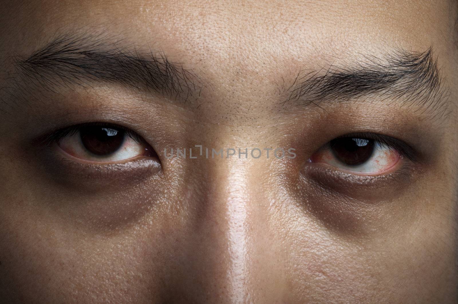 Close up male eyes. Insomnia in late night.