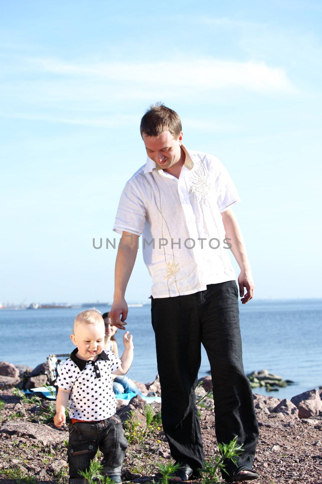 father and son walking on grass