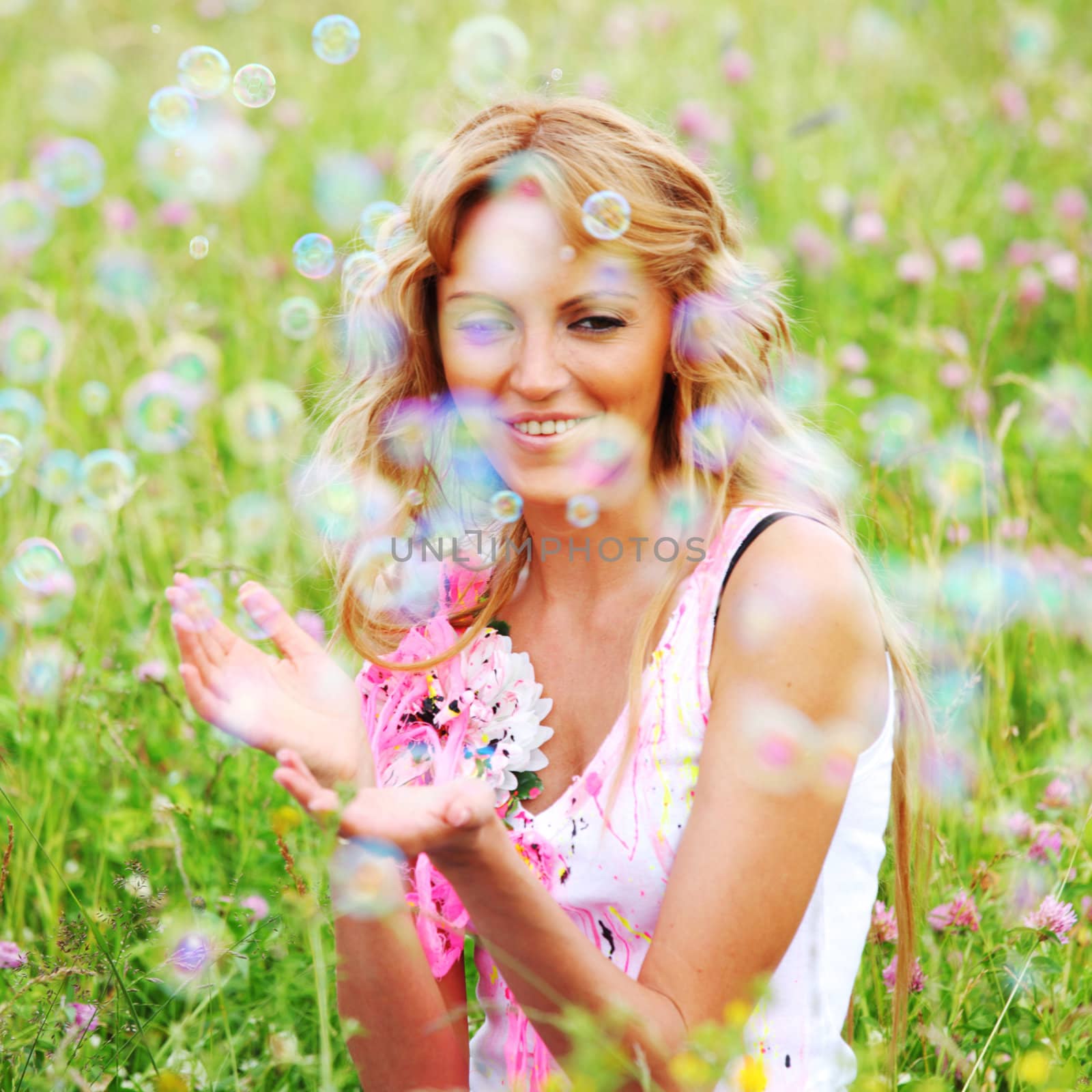 girlfriends on green grass field in soap bubbles