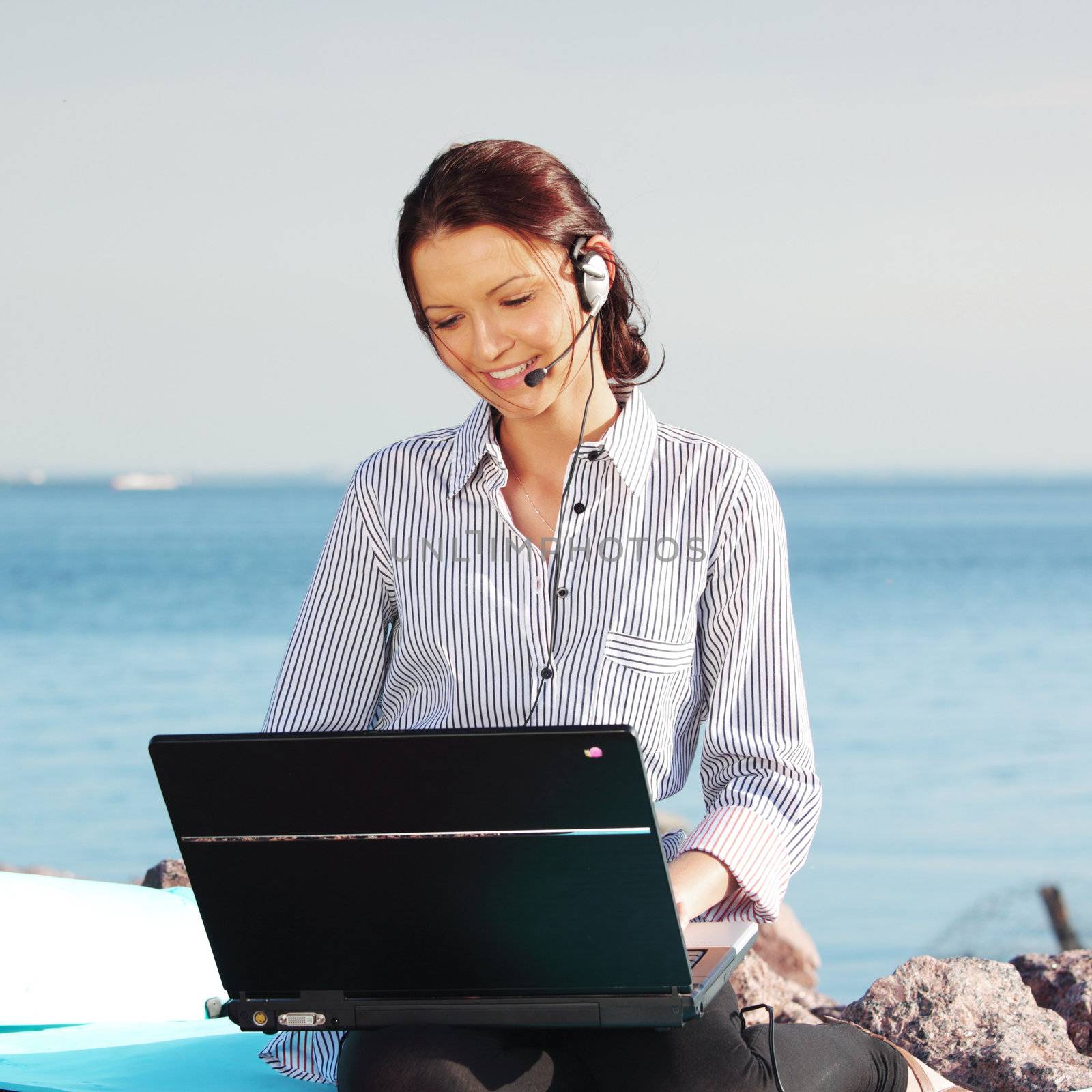 woman with laptop sea background