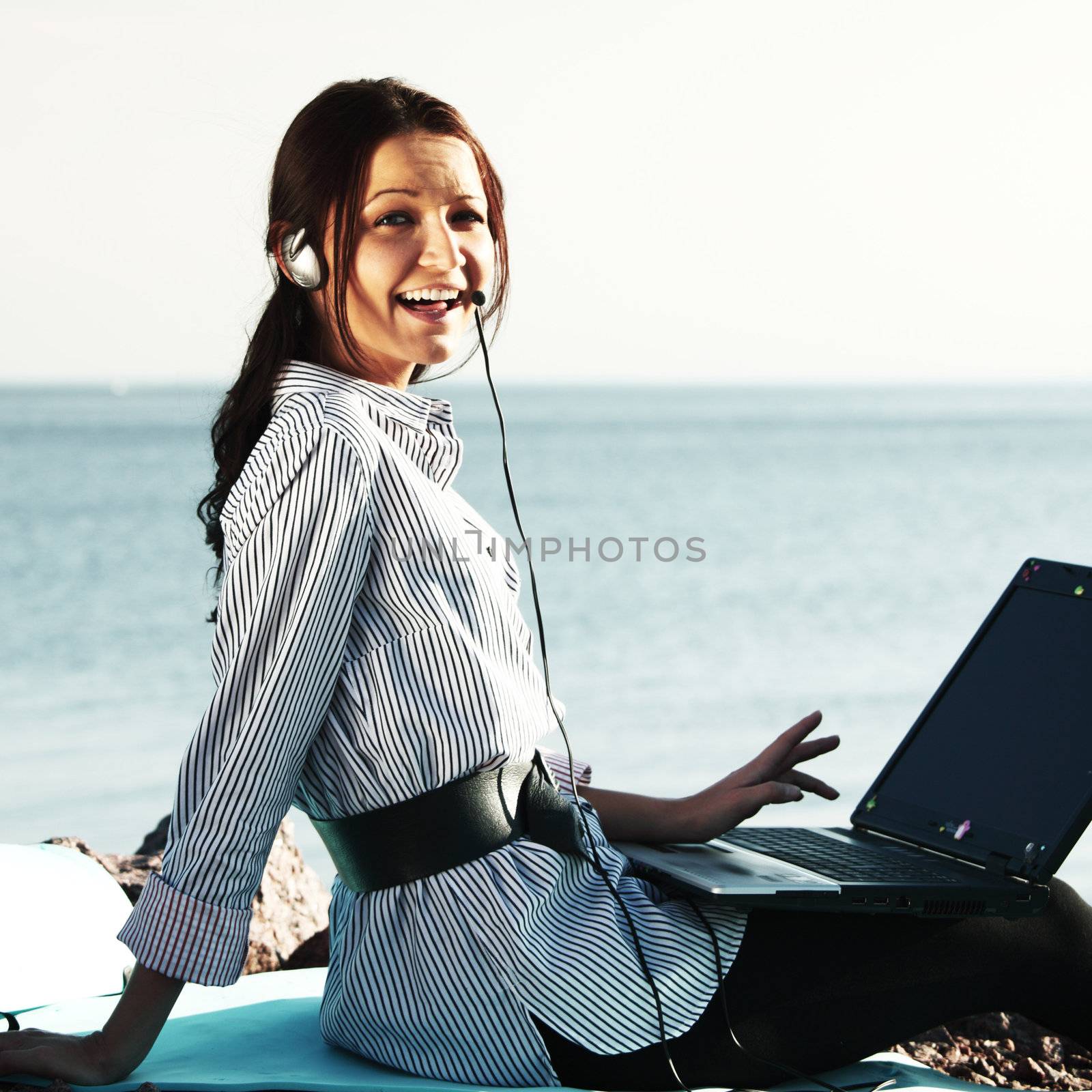 woman with laptop sea background