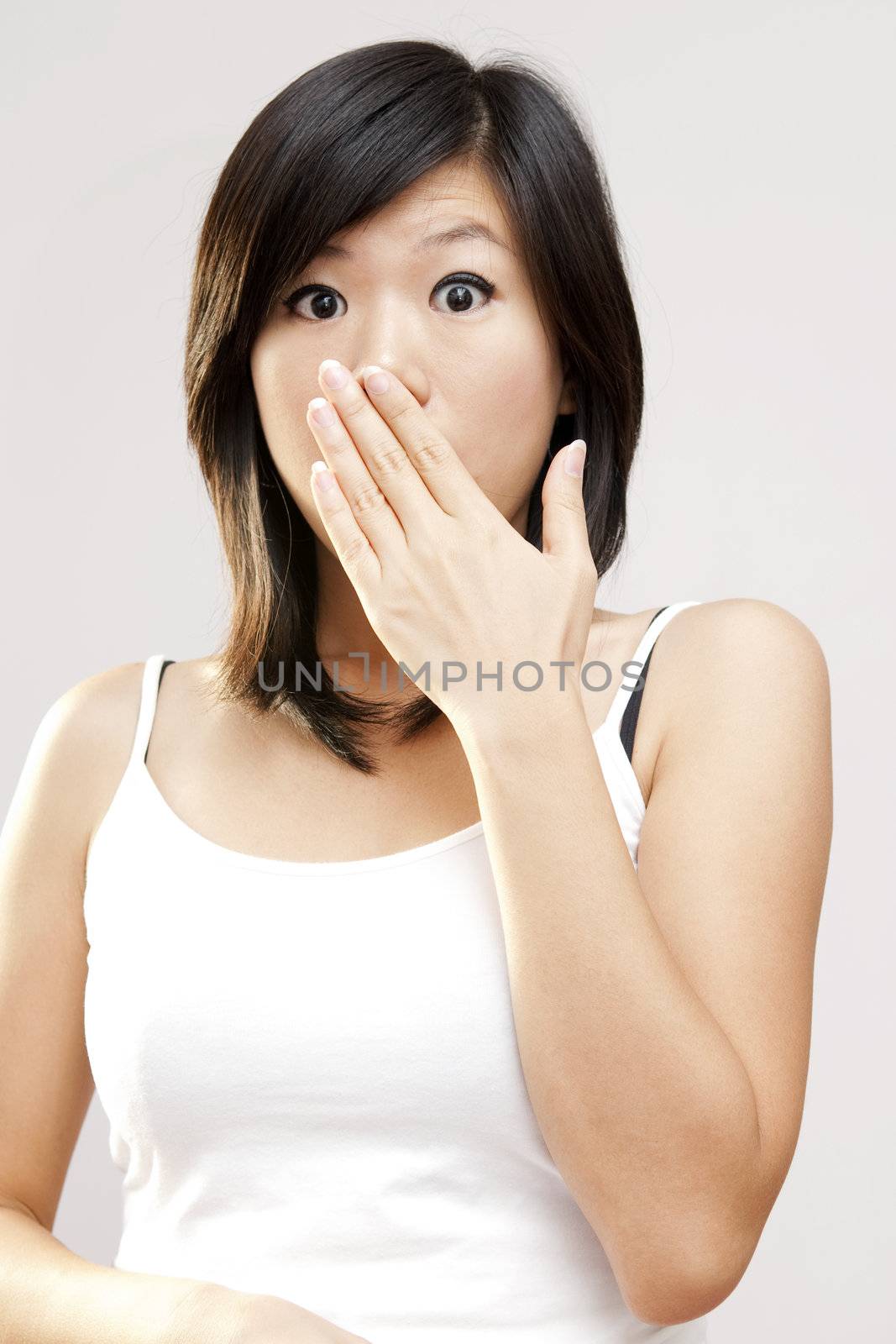 Shocked woman covering her mouth by hand.