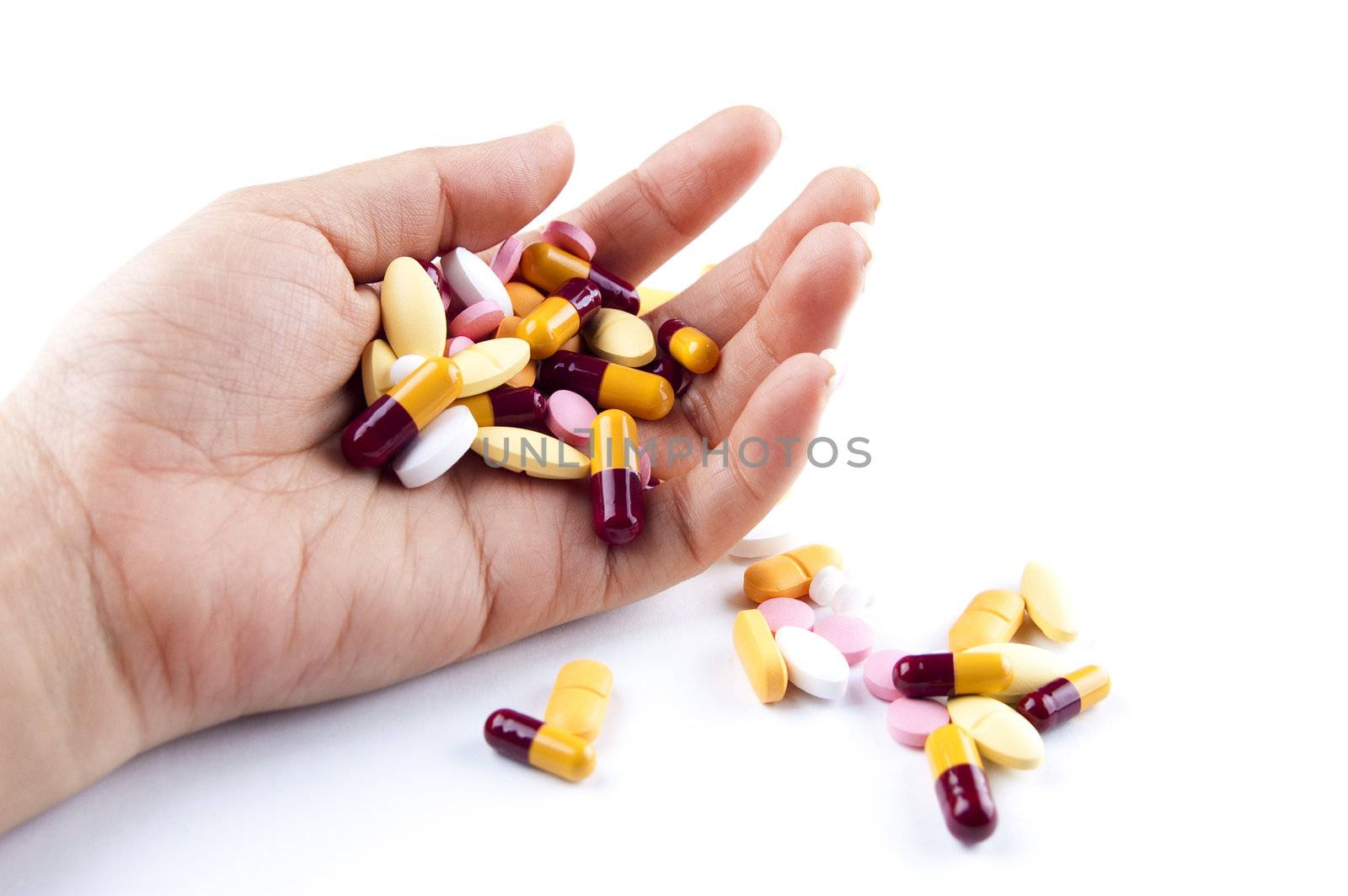 Hand with medicines isolated on white background