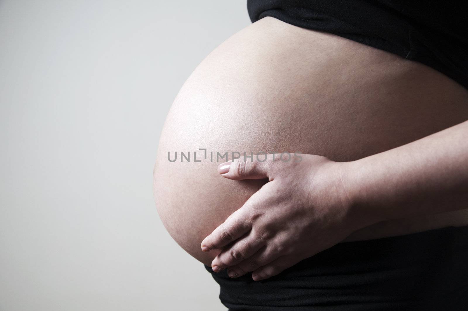 Woman holding her 8 months pregnancy belly