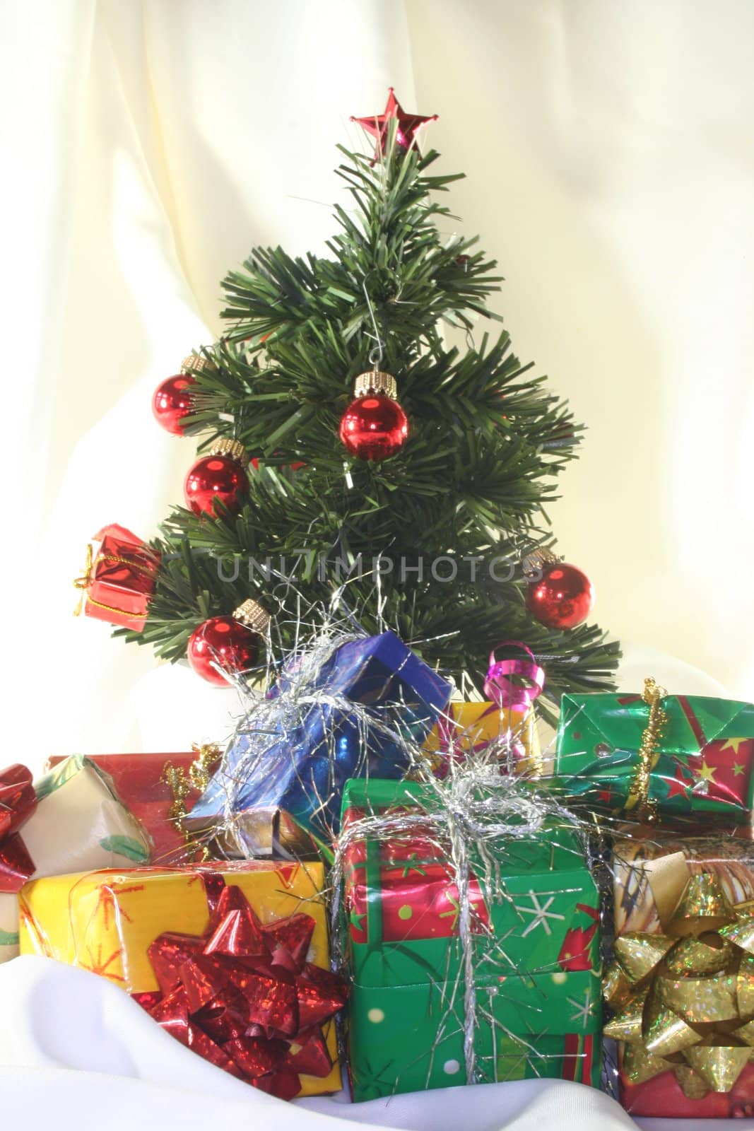 Christmas tree with gifts on a light fabric
