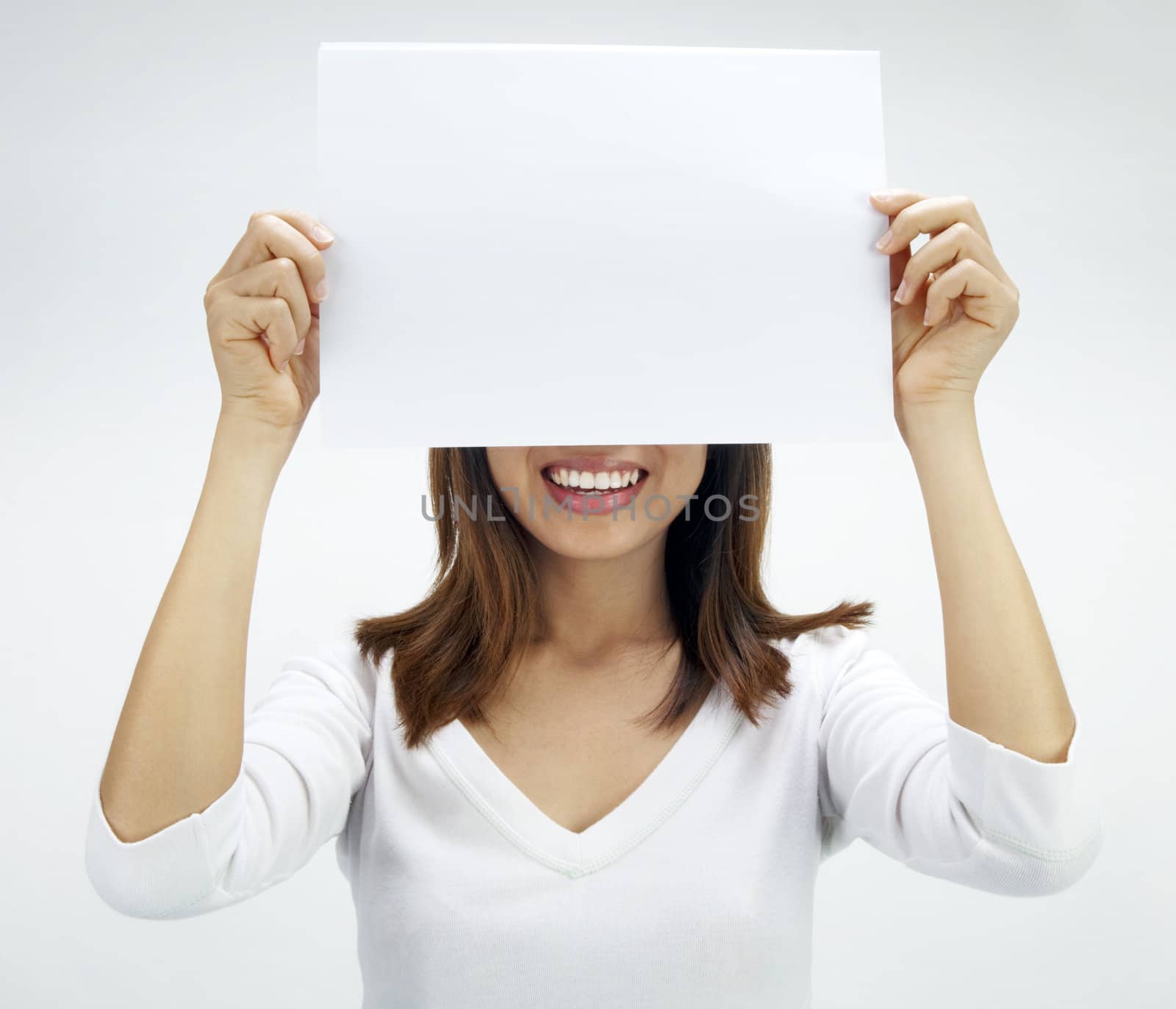 Concept photo of Asian woman holding a white card, covering her eyes.