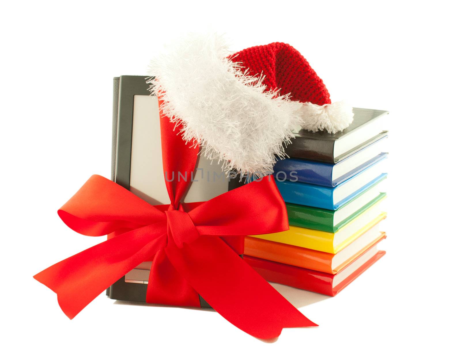 Electronic book reader wearing Santa's hat with stack of books