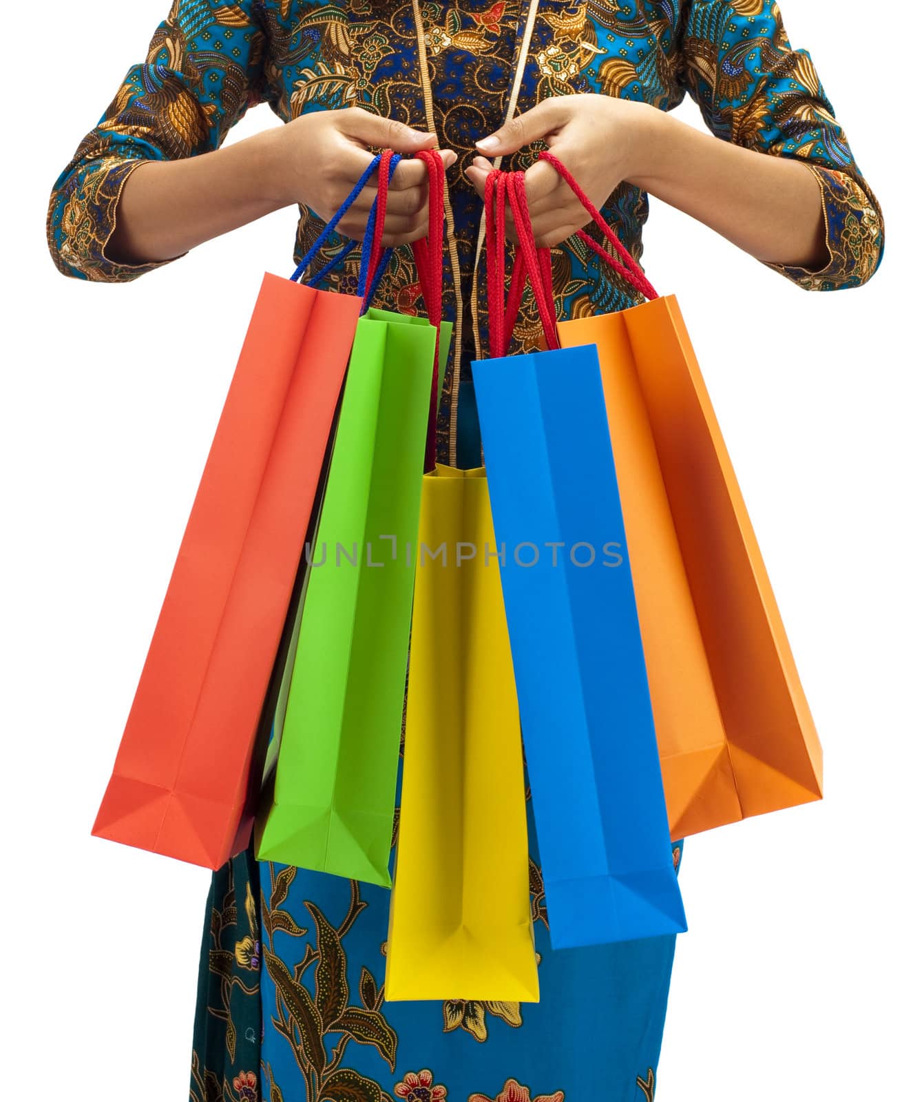 Woman in tradition Kebaya holding colorful shopping bag.