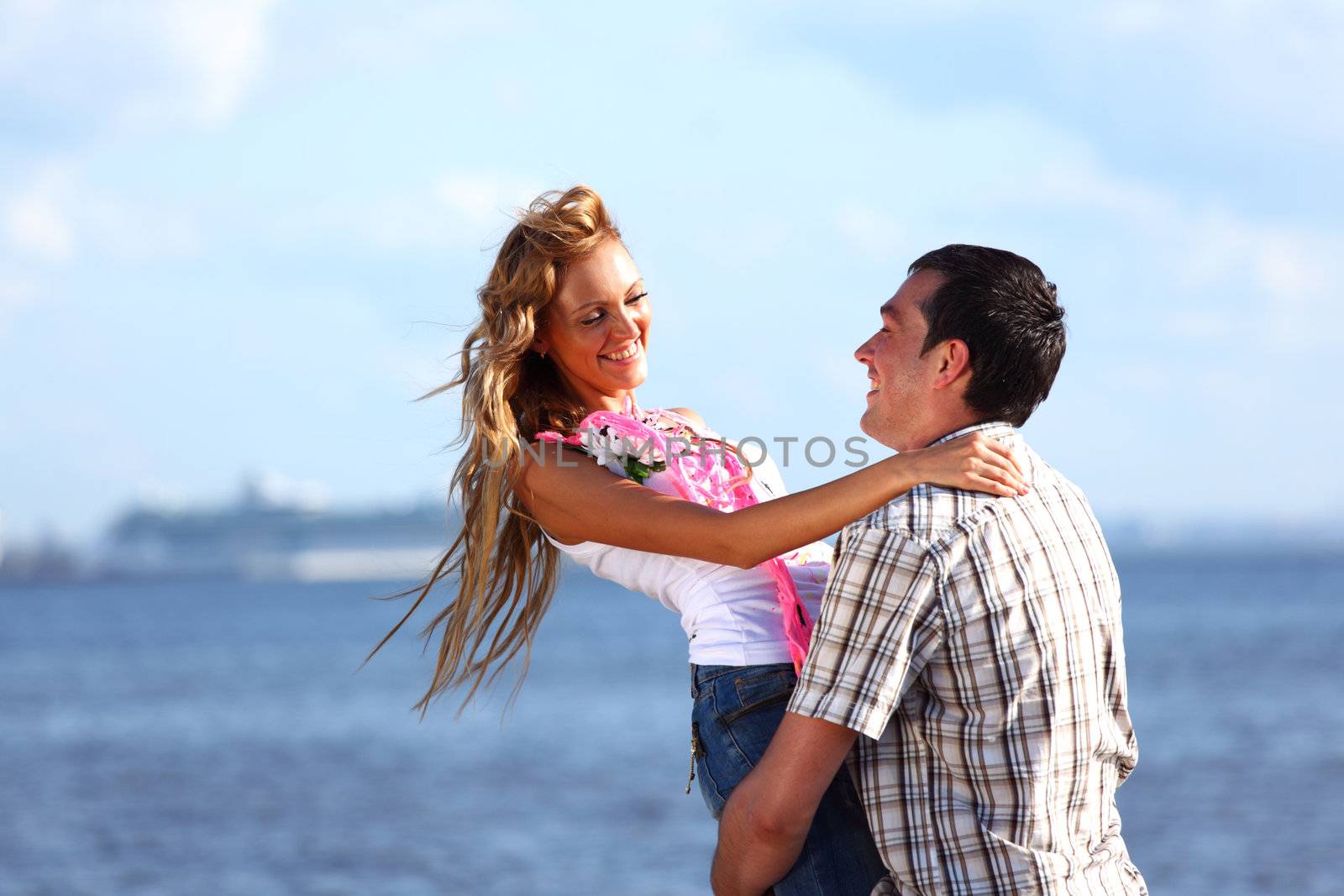 man and woman hug in the sky and sea on sea