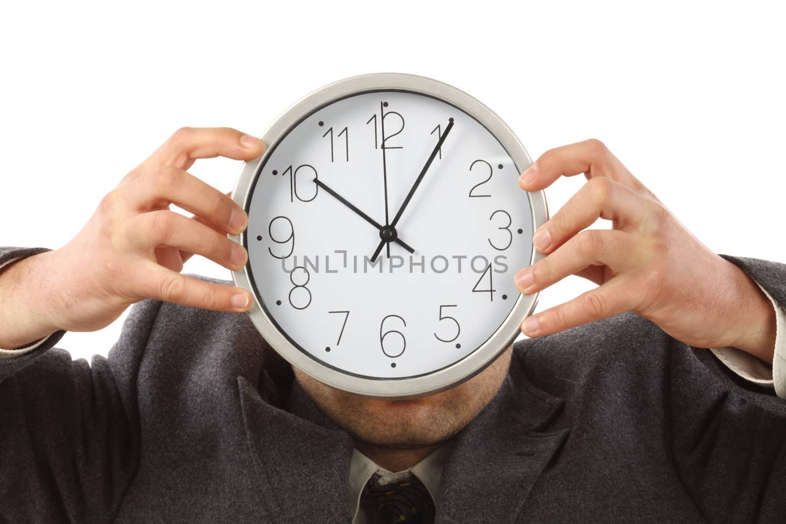 Businessman hiding behind the big clock. Time for work concept 