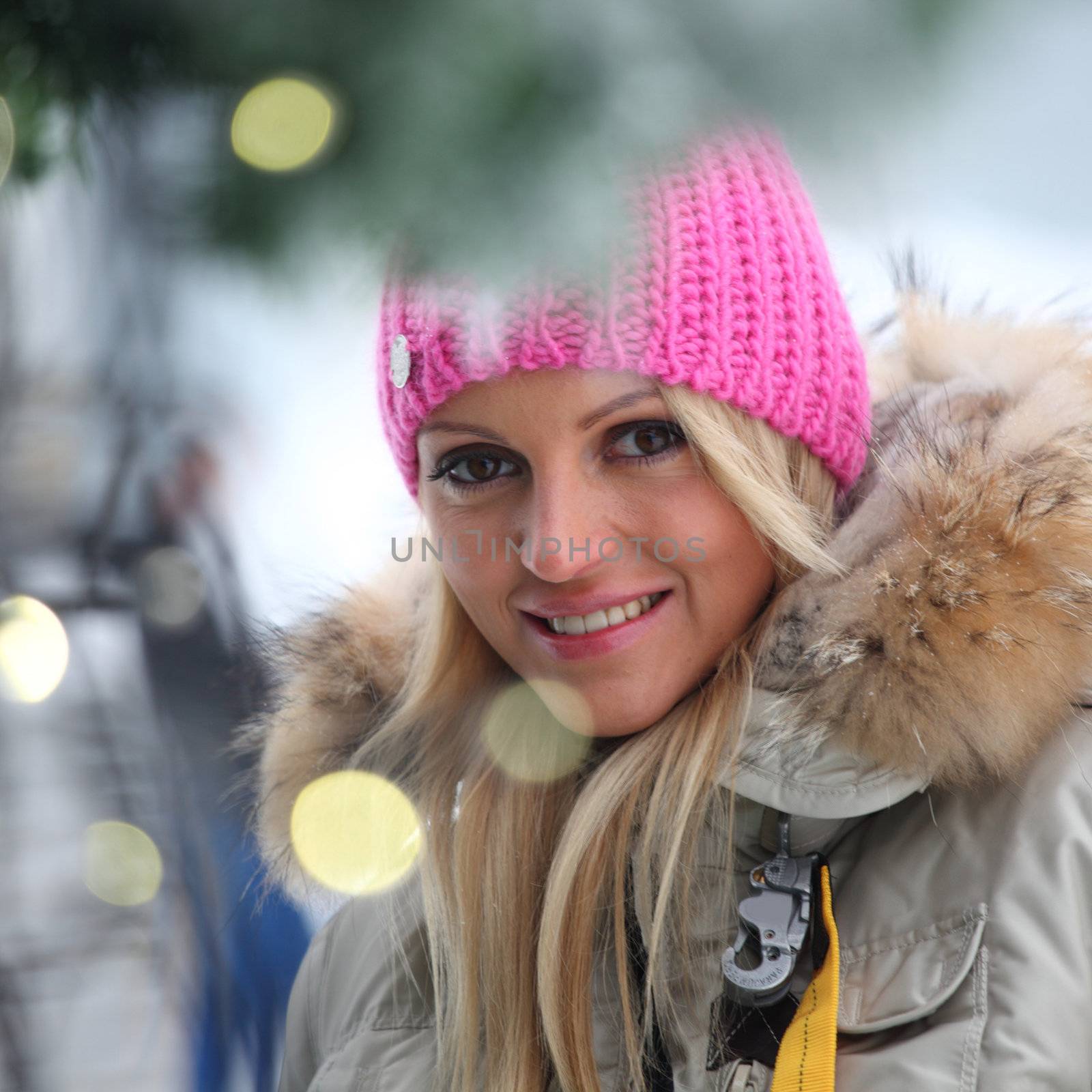 woman in winter hat and holyday bokeh