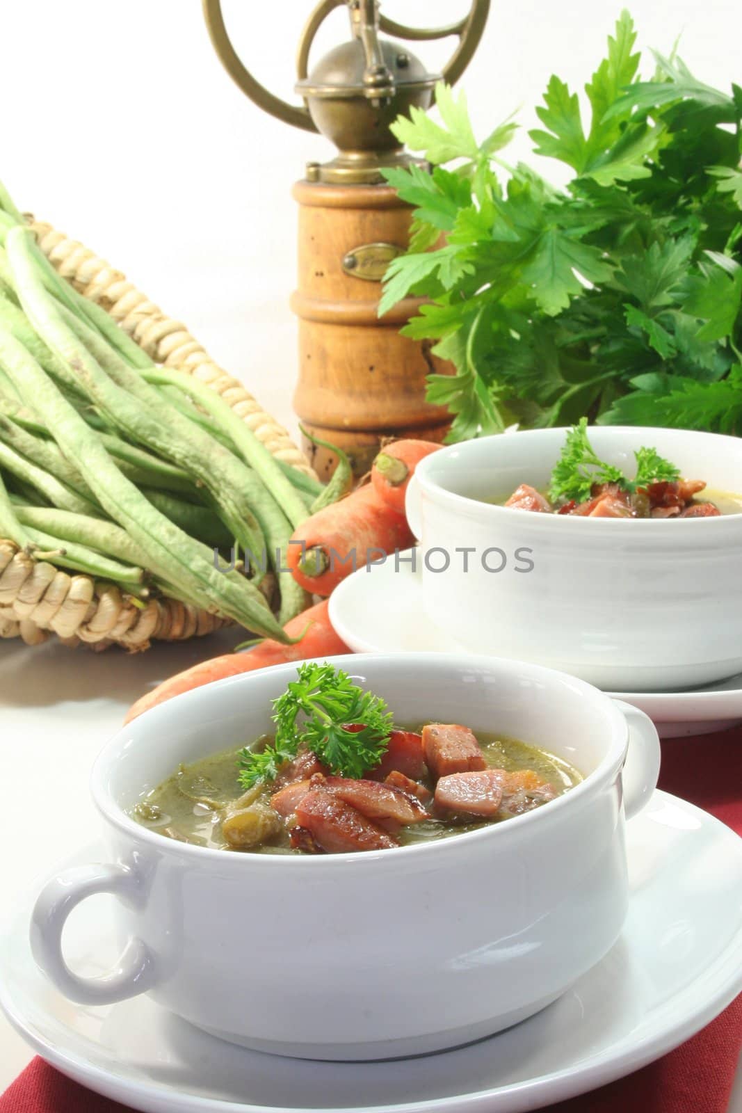 Green bean stew in a white soup cup