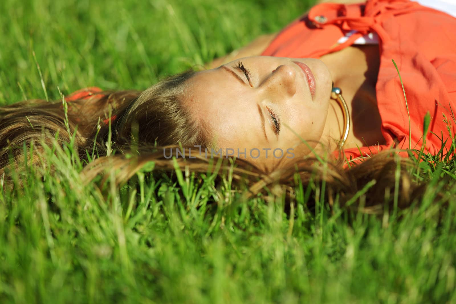 young sommer woman on green grass