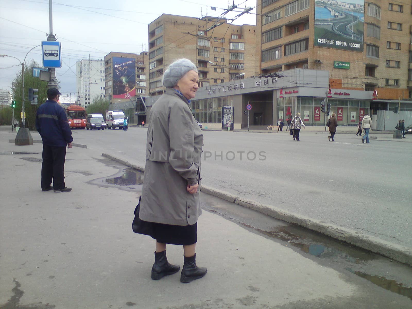 Fascinating old lady, waiting for the bus in centrum of Murmansk, Russia.