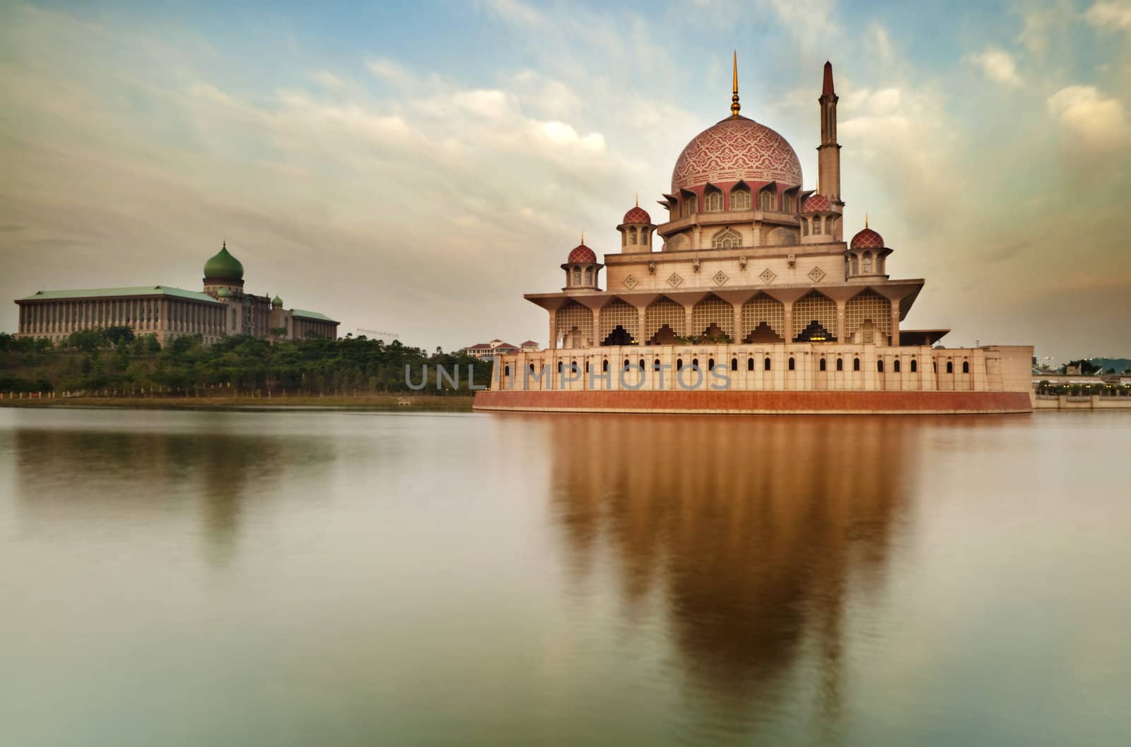 Putra Mosque is the principal mosque of Putrajaya, Malaysia. Building on the left is Perdana Putra which is Malaysian Prime Minister's office.