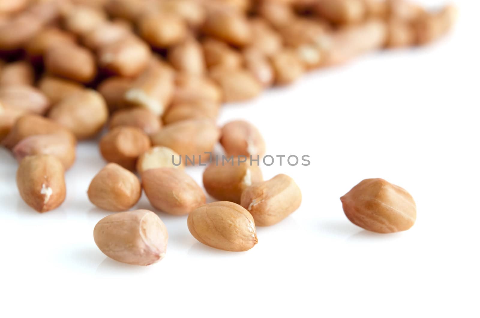 Closeup peanuts with skin isolated on white.