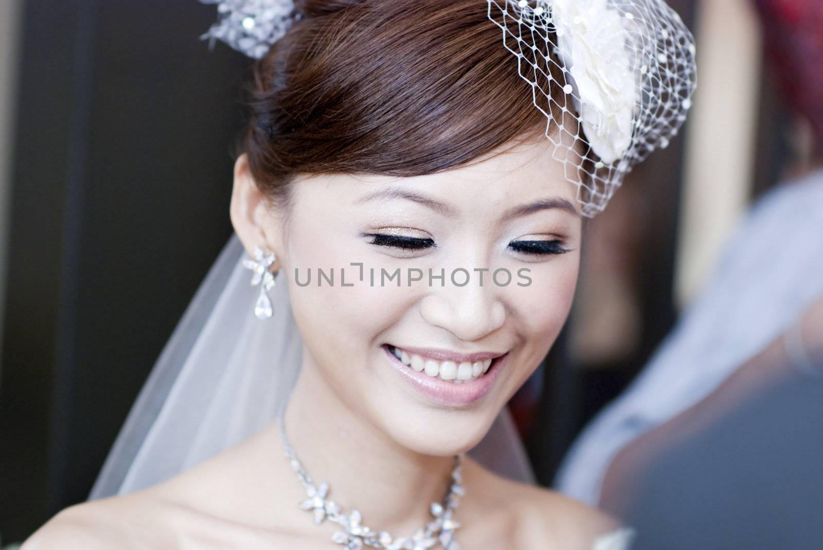 Candid moment of beautiful Asian bride smiling