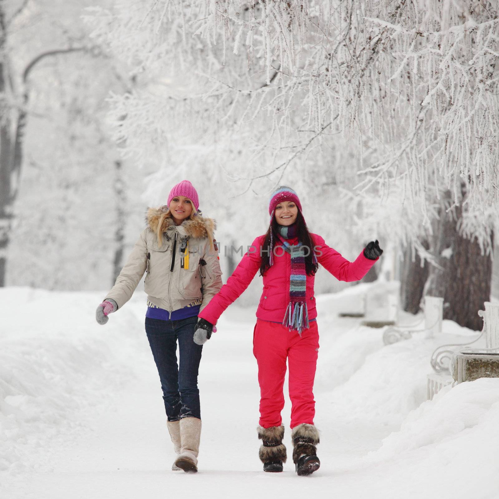 two winter women run by snow frosted alley