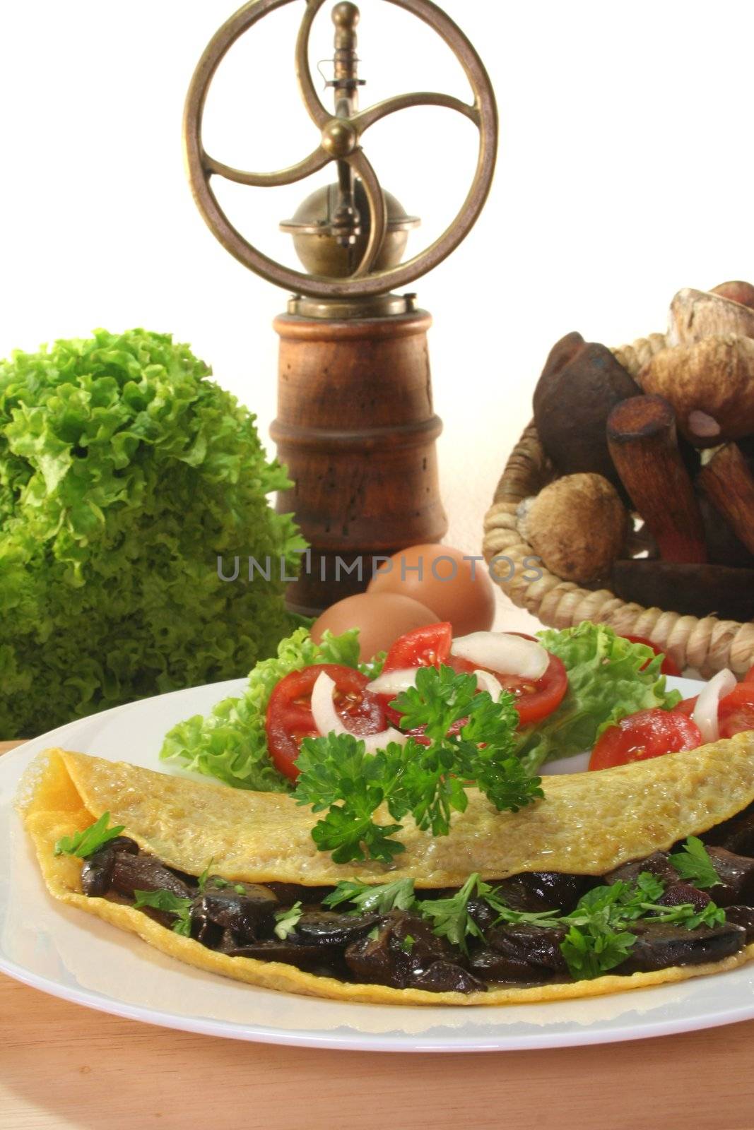 an omelet stuffed with wild mushrooms and fresh salad