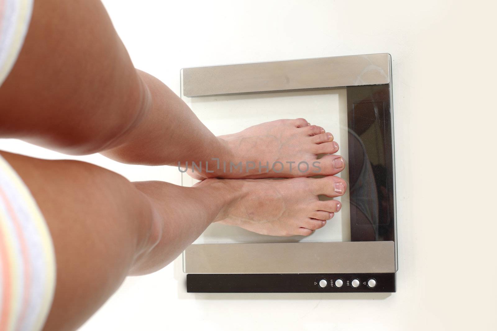 legs on scales isolated on white background