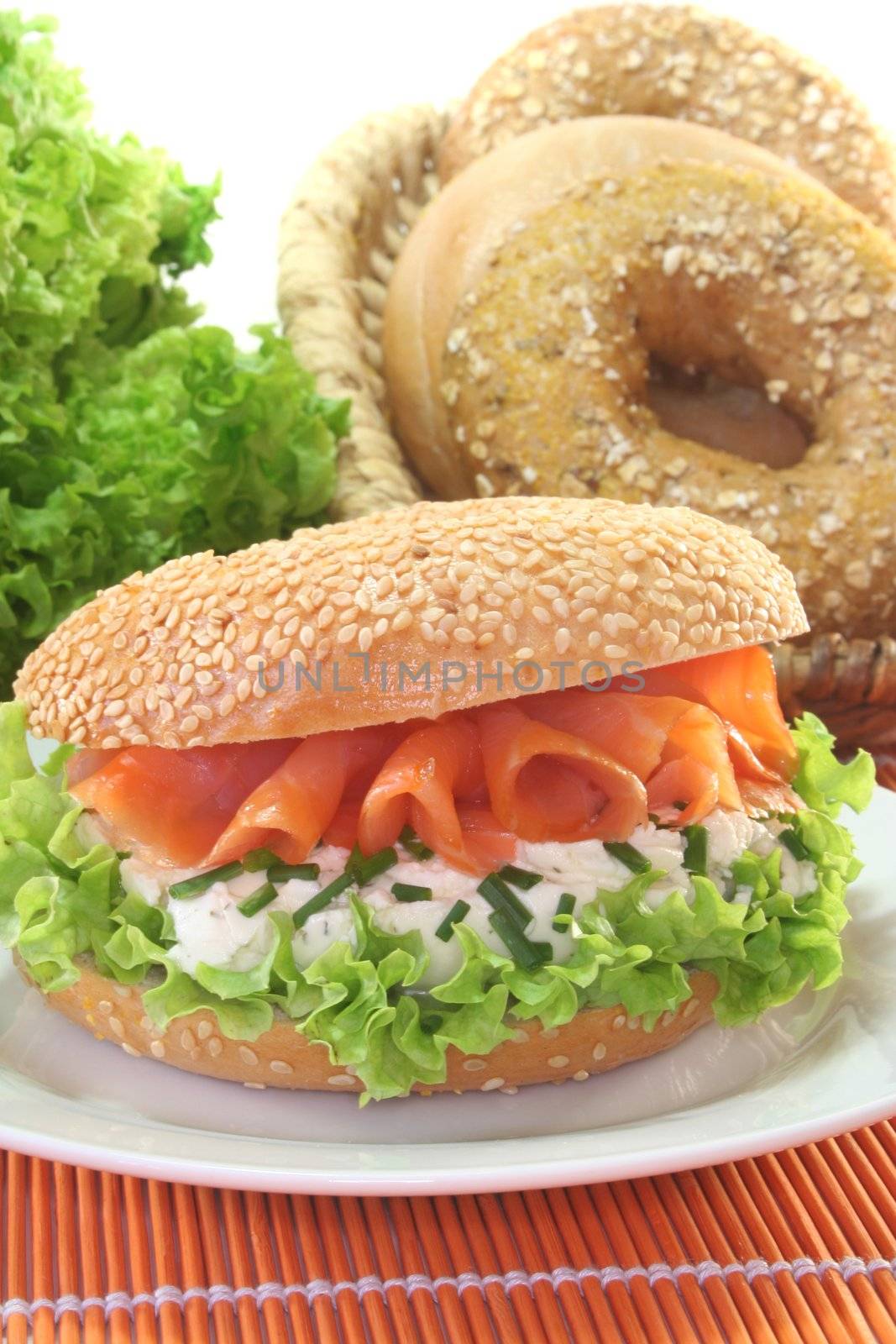 Sesame bagel with lettuce, cream cheese and salmon