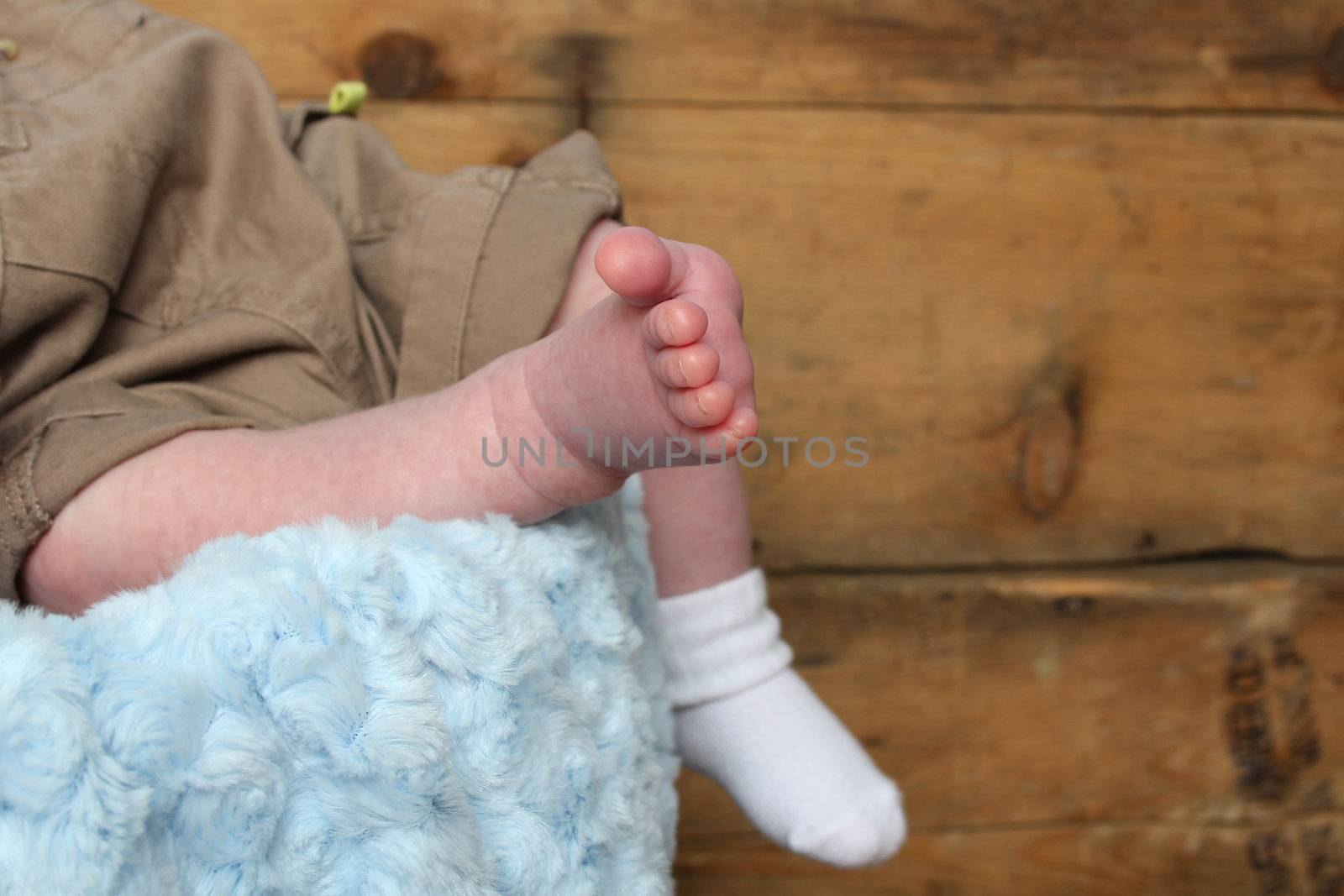 Newborn baby foot with other foot in sock