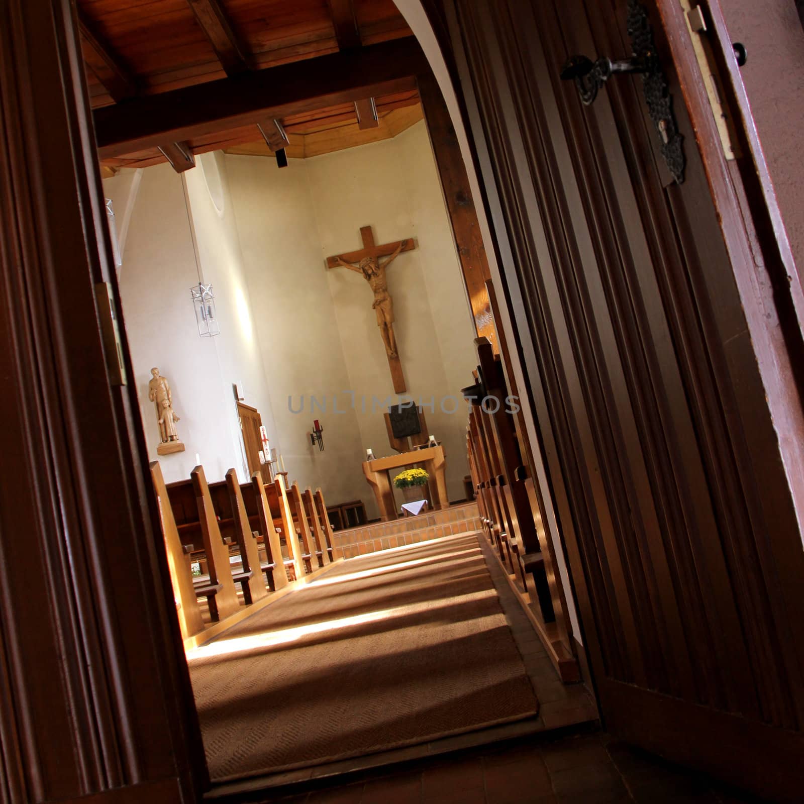 the wooden church with cross on the wall