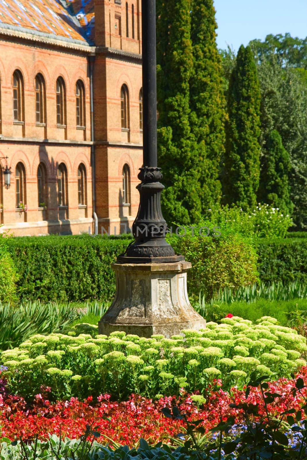 Bed, flowers, building, green, brick, lawn, bed, column, iron, old, red, white, fence, leaves, summer, trees, windows, roof, floral, flowers