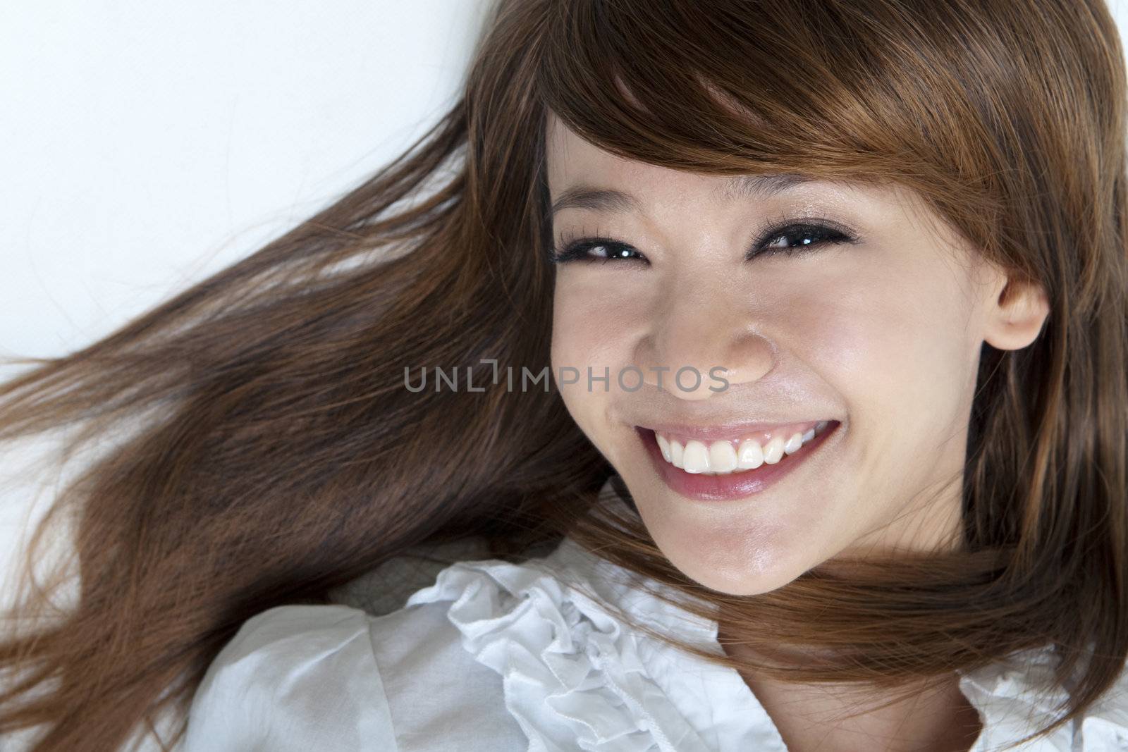 Closeup portrait of happy young girls lying on ground 