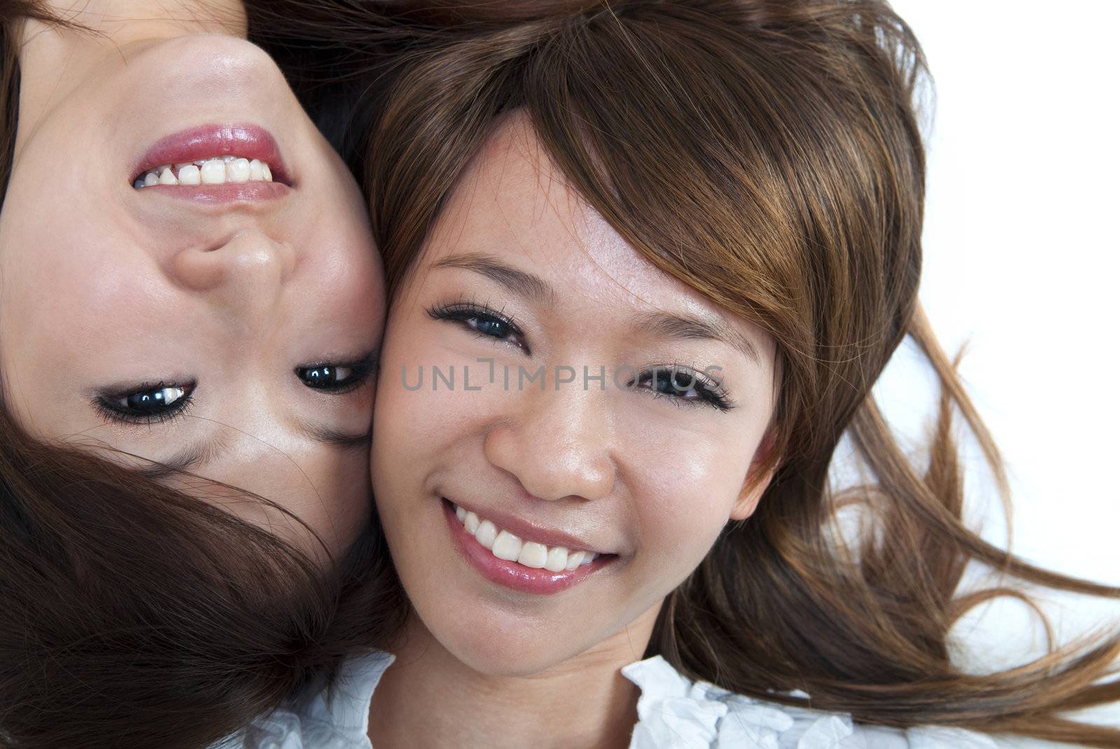 Close up two cute girls lying on floor