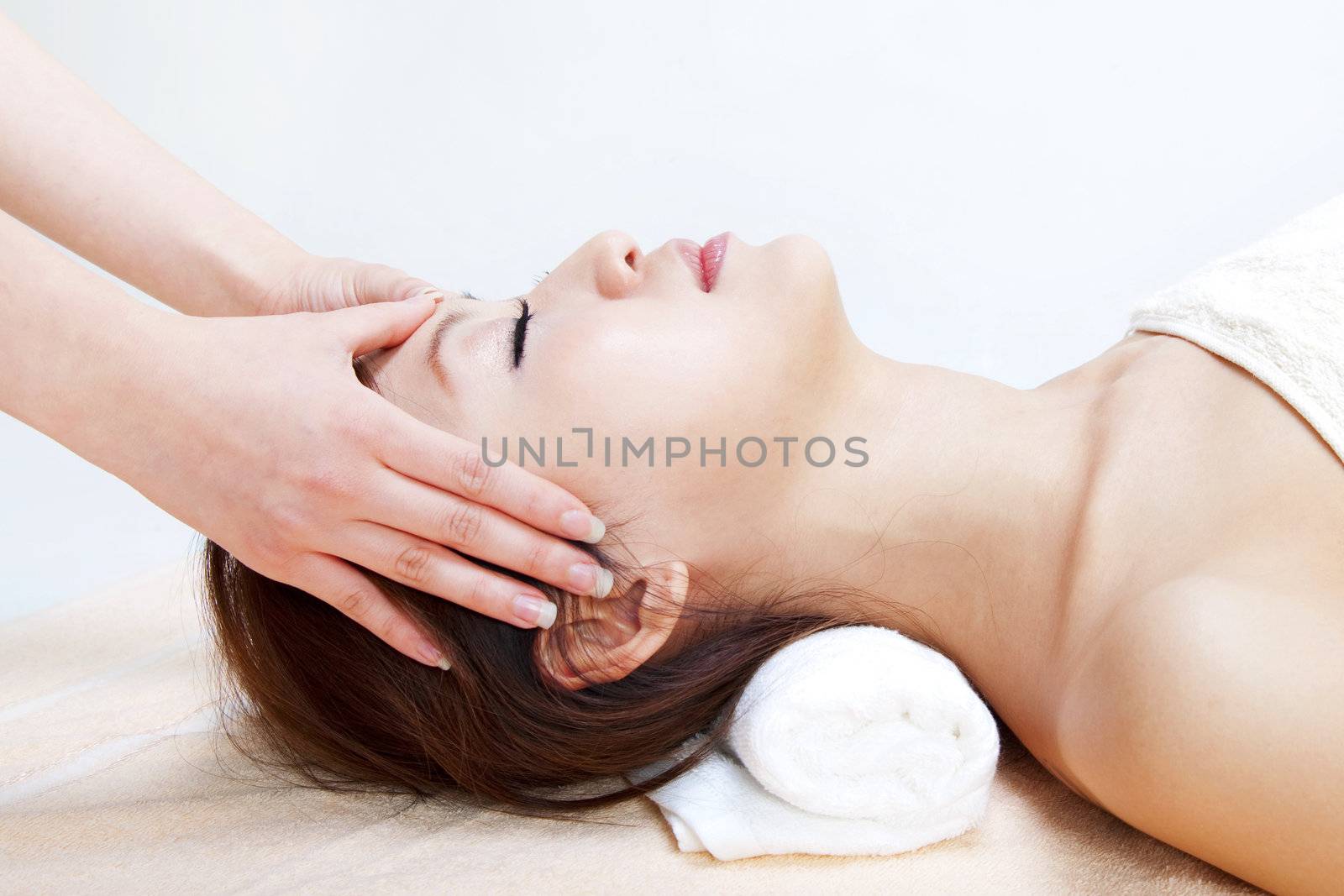 Beauty and Spa - Asian Girl having a massage on her head