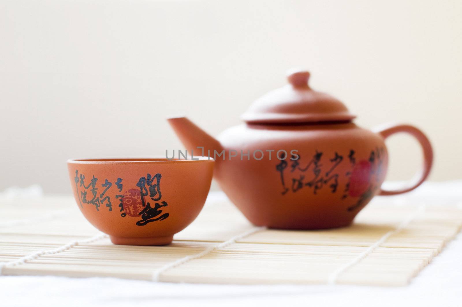 Chinese ceramic teapot and cups. The Chinese word on the pot is a poem.