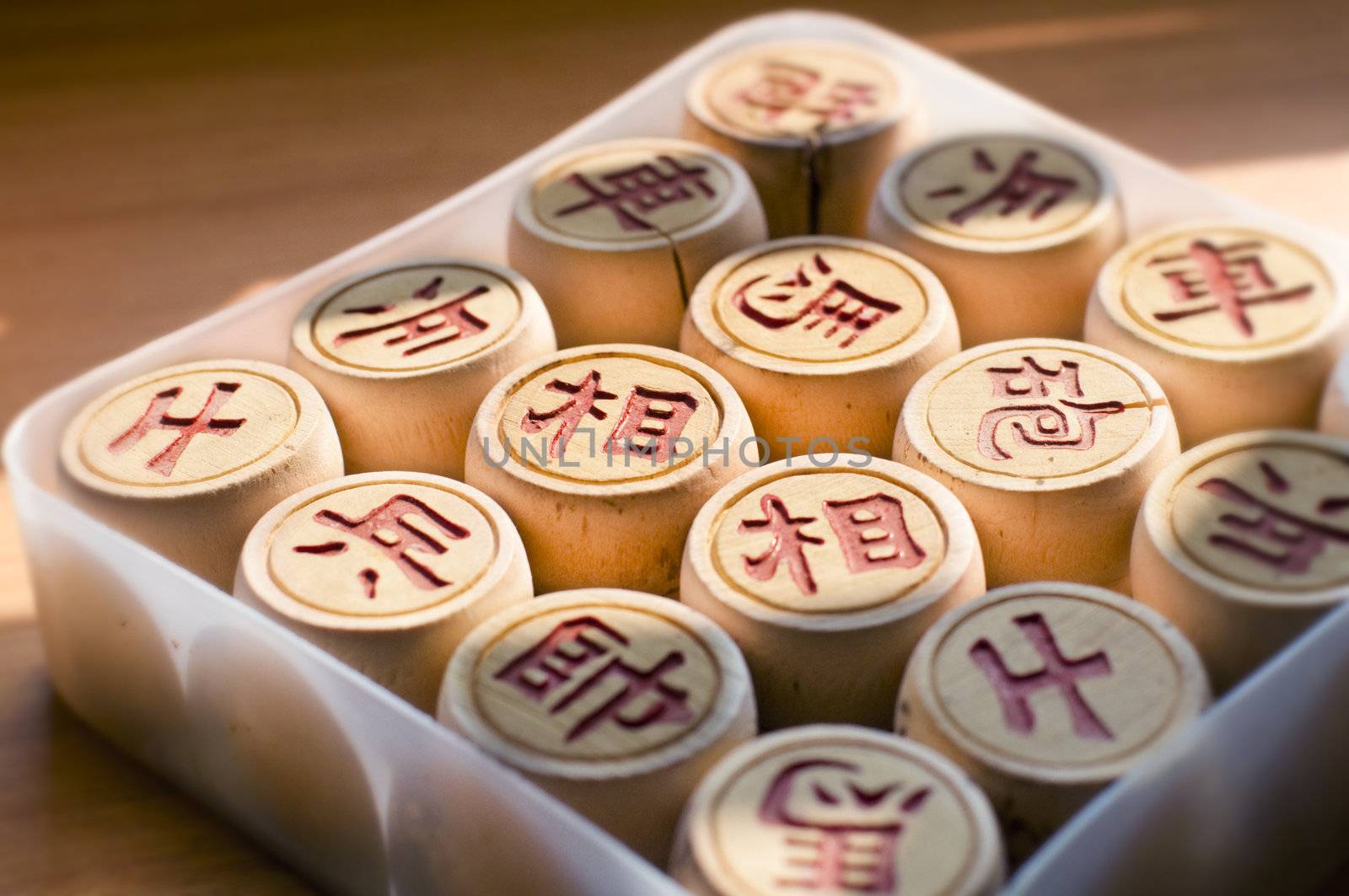 A Chinese Chess Set on a table with natural sunlight.