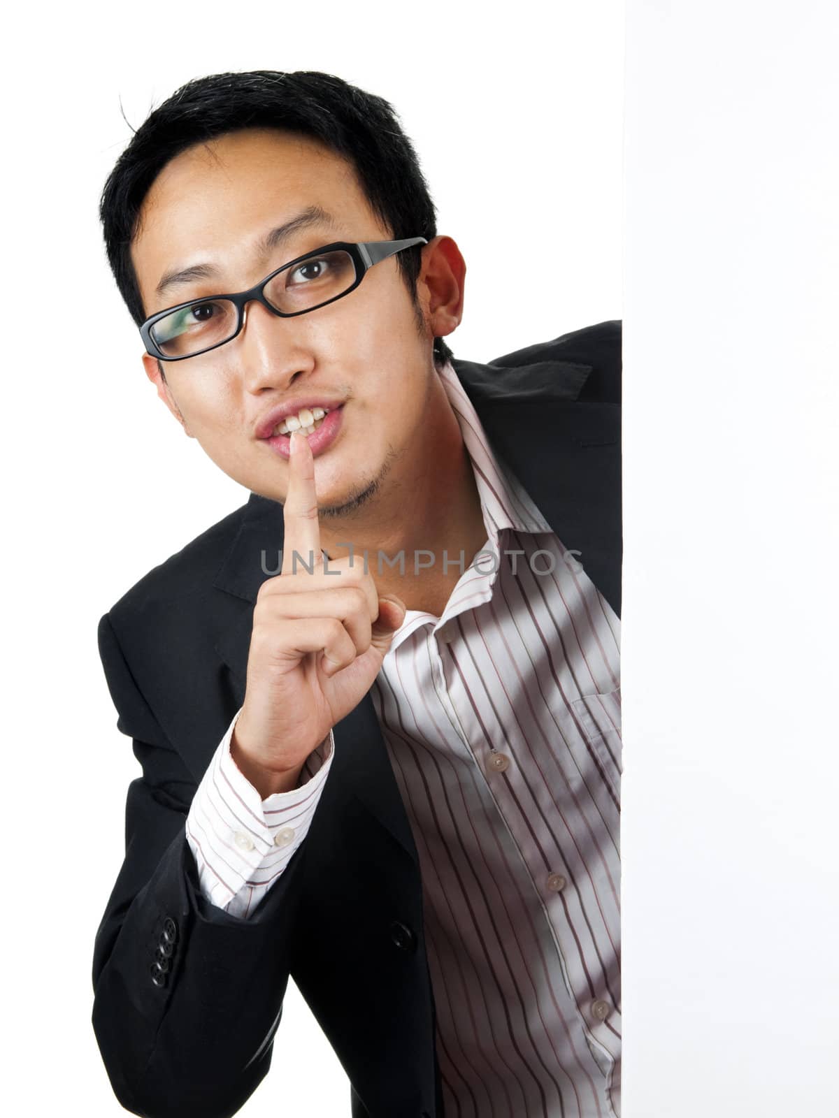 Asian man with blank board, finger on lips